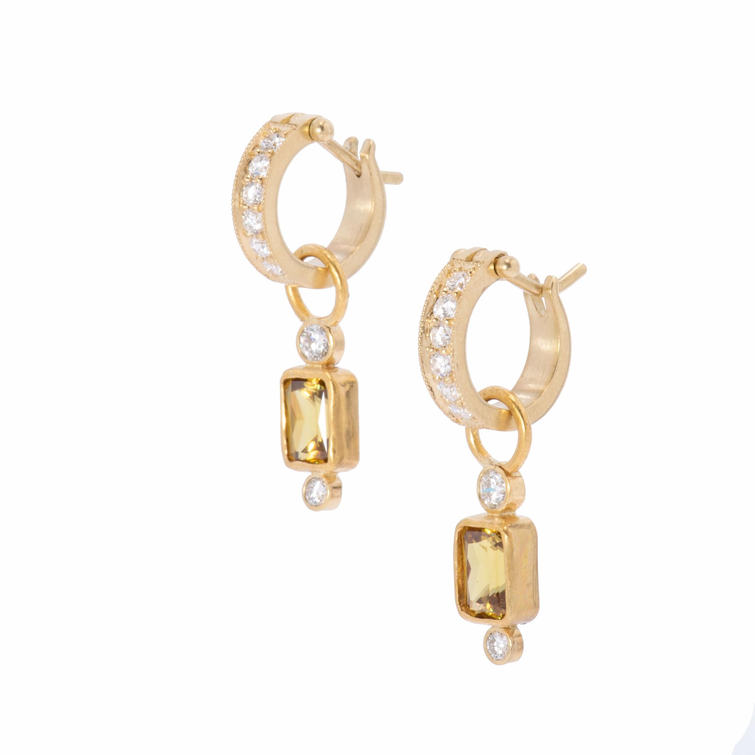 Sphene and Diamond Drop Earrings in 18k gold are handcrafted in our studio of natural sphene, an unusual stone and dazzling in this emerald cut. Honey gold lights flash from emerald cut sphene 2.5ctw. and are balanced with round white diamonds