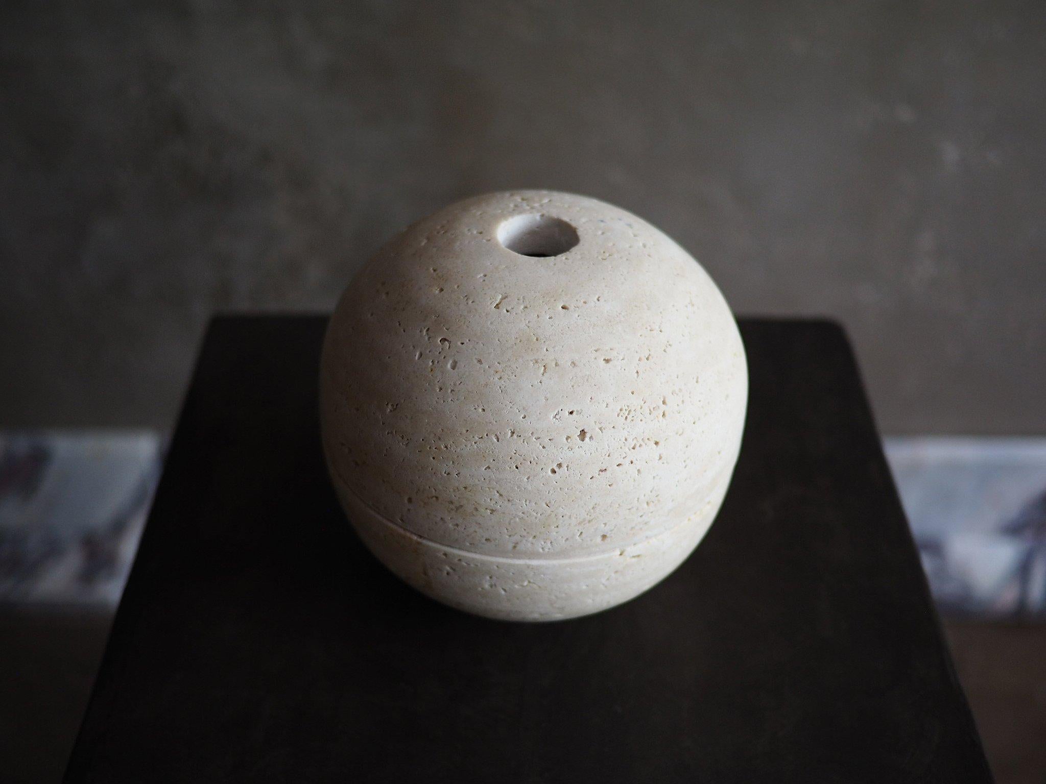 Sculpted from solid blocks of Unfilled Beige Travertine, Sphere Censer by Brendan Tadler. Minimalist in form, the Sphere Censer acts as a quiet object to stimulate creativity and focus when activated with incense or sage. Inside the sphere, burn
