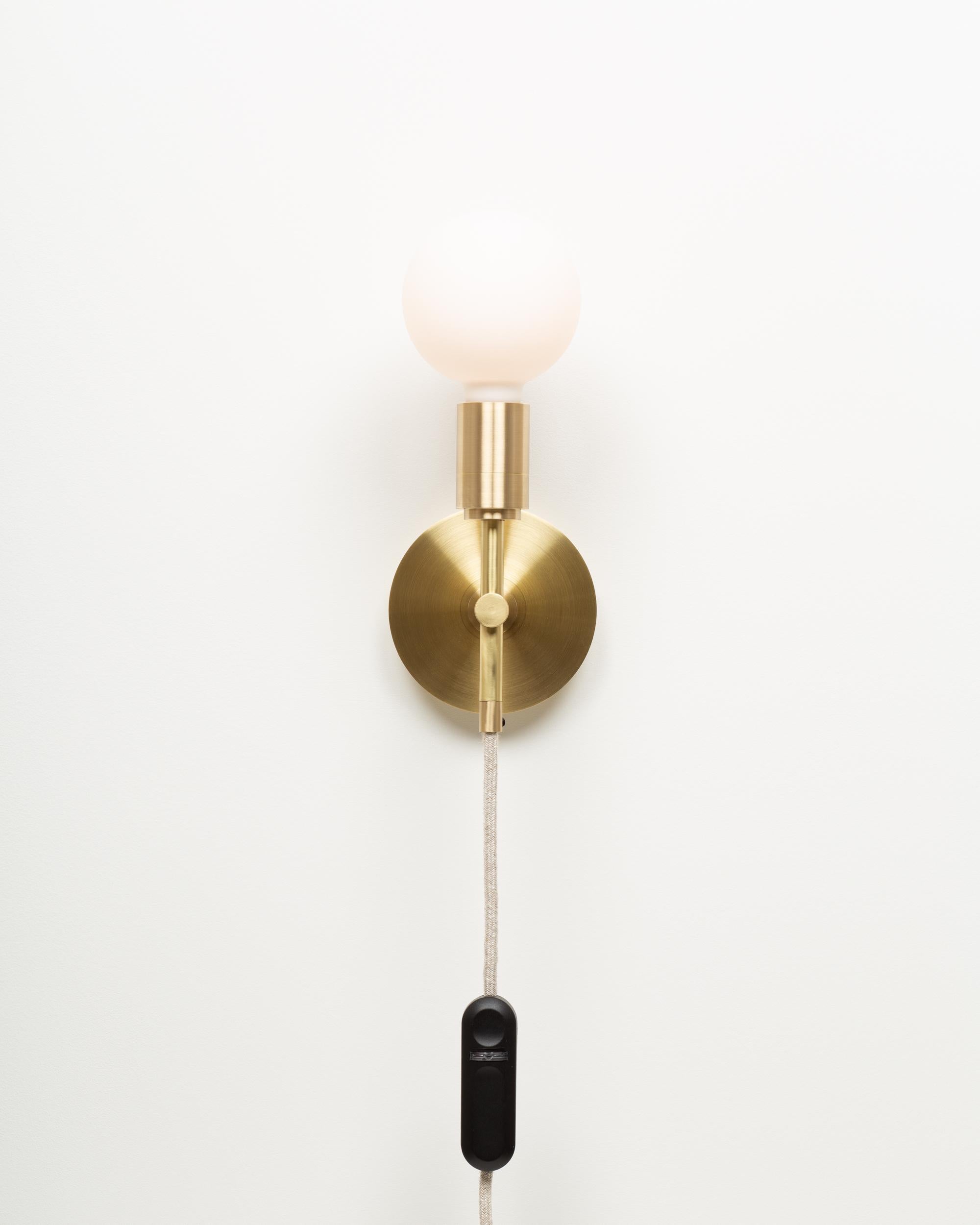 Sphere Wall Light
Brushed brass wall plate
2000K - 2800K  95CRI
600 Dim to Warm Lumens 
Surface mount with Integrated Dimmer
Sphere III Bulb Included
USA spec available on Request. 
Handmade in Hackney Wick, by Lights of London.