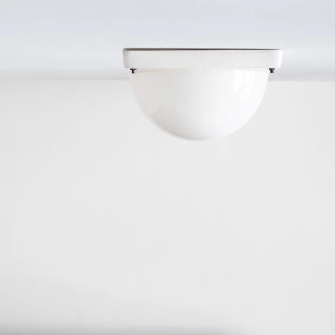 Clean, minimal half-sphere light from Italy. Can be mounted either on the wall or ceiling. Soft diffused light and simple geometric form make it an elegant accent for any interior.