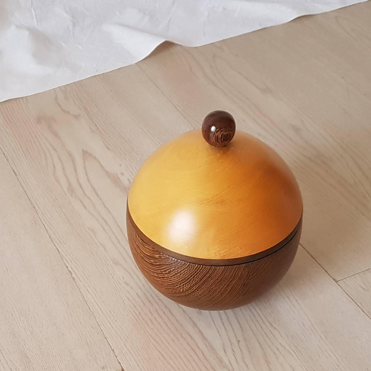 Spherical box from Finland manufacturer in maple and wengè wood.
It is a part of a collection.
The collection is composed by others boxes that have different geometric shapes (pyramidal, cylindrical,...) but same finishes.
 

 
