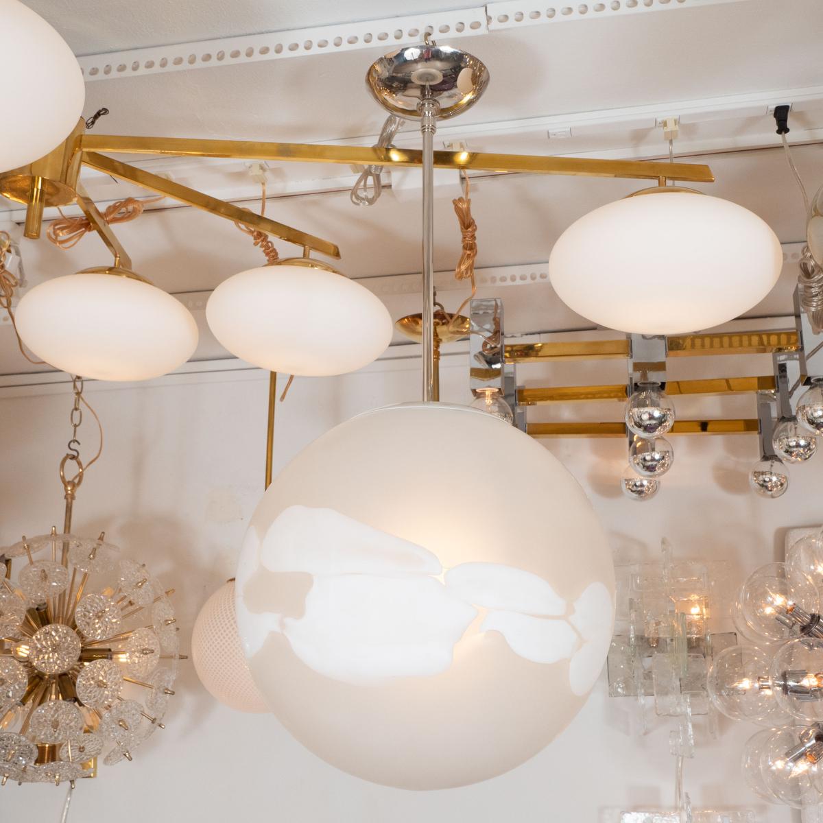 Spherical frosted glass pendant ceiling fixture with white lattimo details.