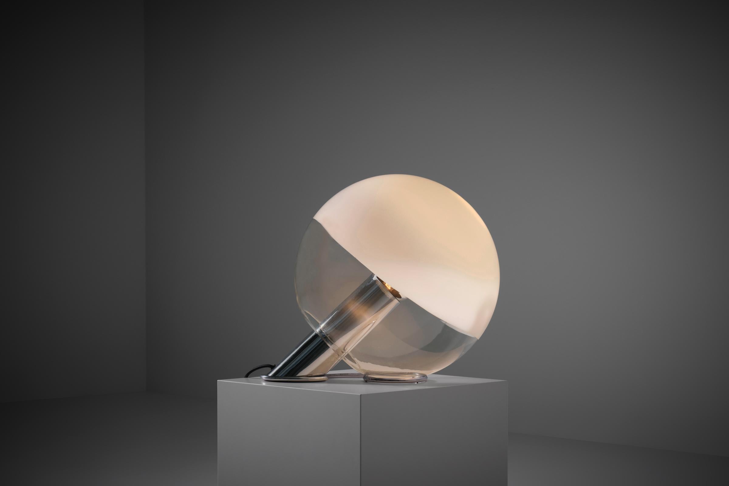 Rare glass table lamp by Pia Guidetti Crippa for Lumi, Italy 1970s. Interesting sculptural design composed of a glass globe resting on a chromed base with a central diagonal tube. The clean clear globe shape is subtly decorated with an organic