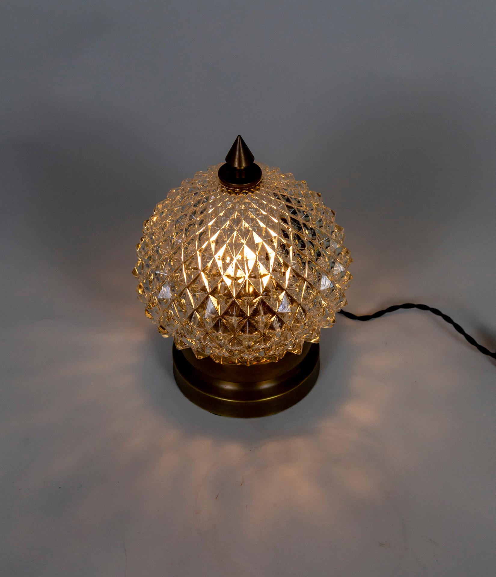A vintage, diamond crystal, pressed glass shade repurposed into a petite lamp with solid brass parts. Newly wired with a dimming switch on the cord. The petite shape and dimming capability make it perfect for mood lighting and bookshelves. One