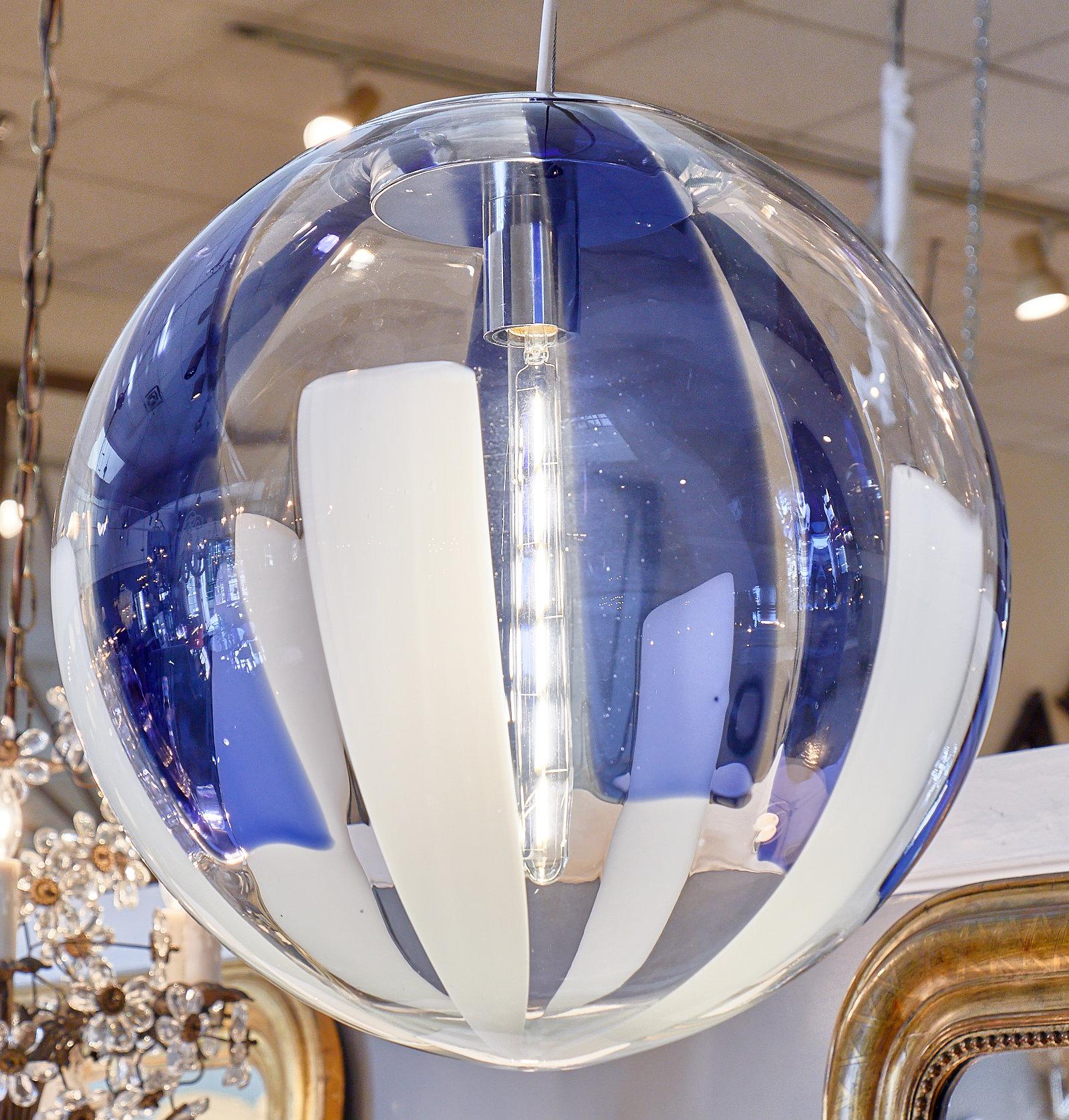 Hand blown Murano glass cobalt sphere chandelier. This globe fixture features a beautiful combination of cobalt blue and white stripes. It has been newly wired to fit US standards.