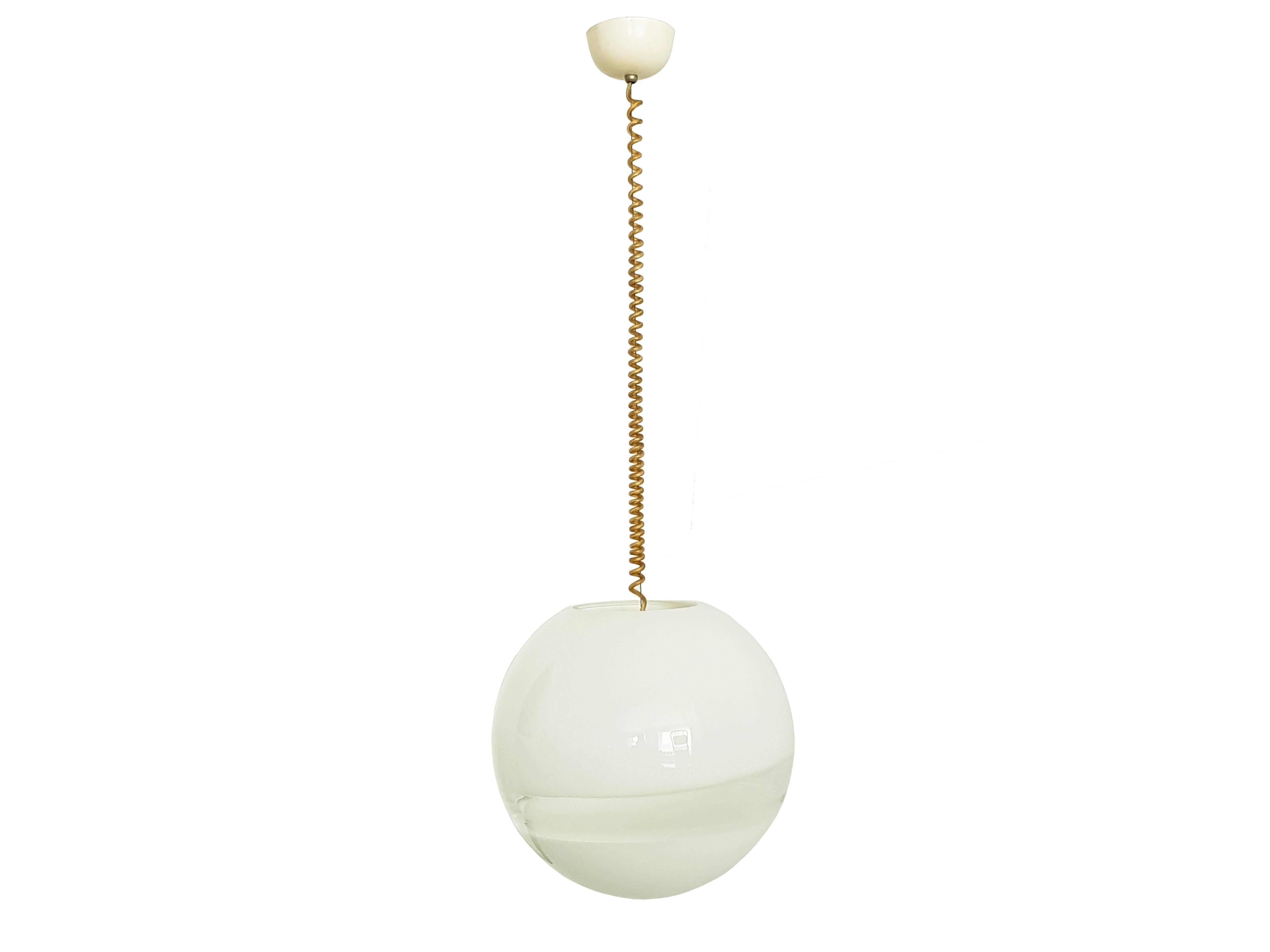 This nice pendant is made from a spherical white and clear Murano glass shade supported by a steel cable. Leucos mark stamped by maker inside the plastic ceiling. Very good vintage condition.