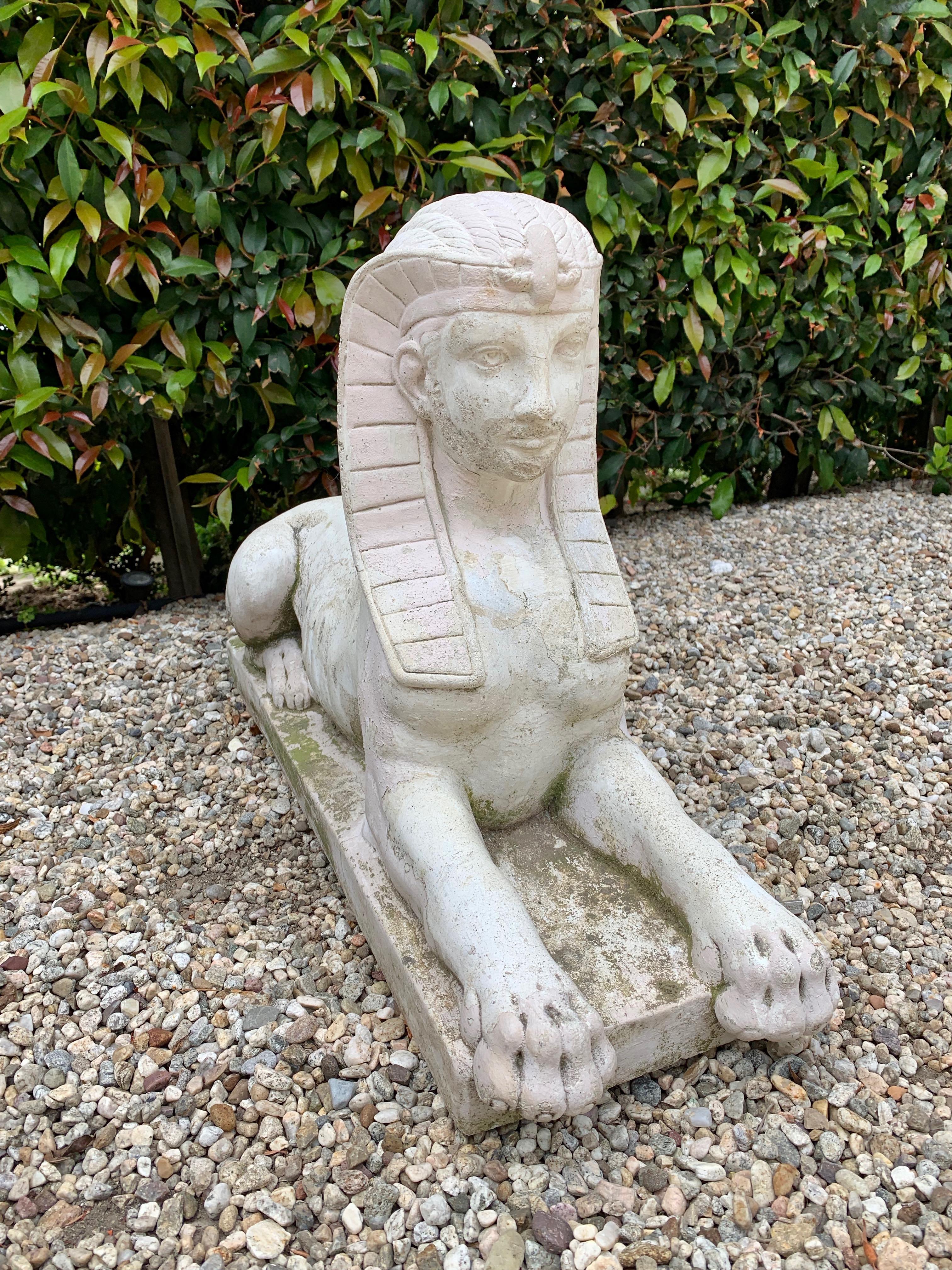 Patinated perfectly with the perfect degree of weathered age - a Cast stone Sphinx, handsome in any garden or path.