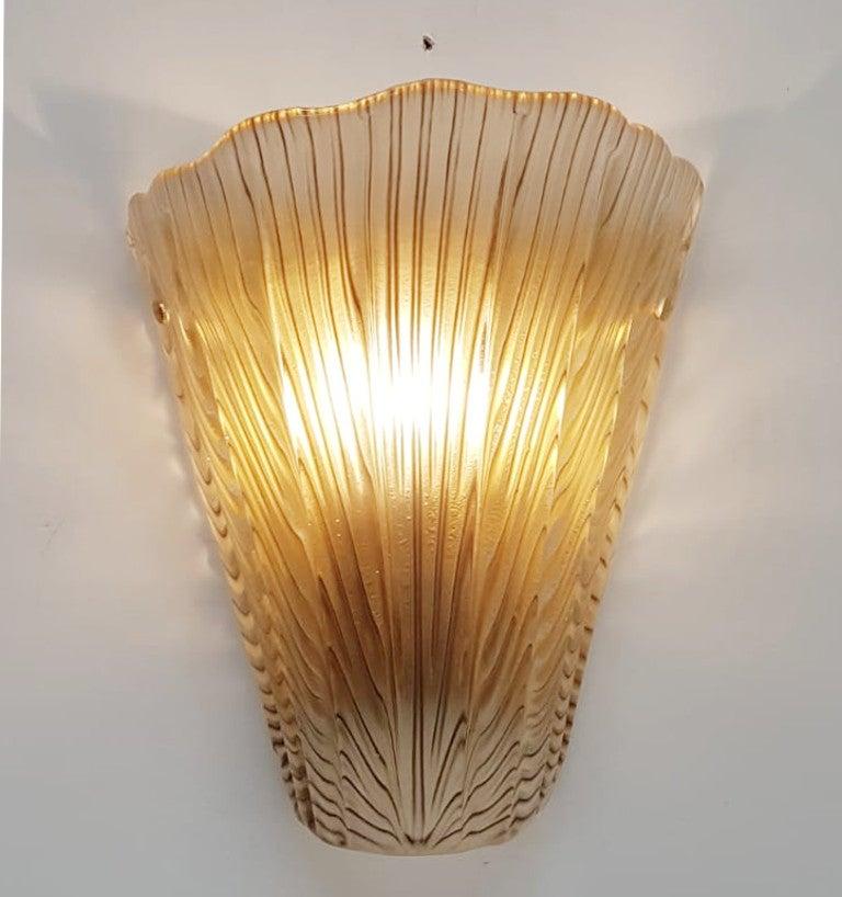 Italian wall light shown in smoked brown Murano glass molded into an artistic shell shape, mounted on un-lacquered natural brass frame / made in Italy
Designed by Fabio Bergomi for Fabio Ltd
1-light / E12 or E14 type / max 40W
Measures: Height 12.5