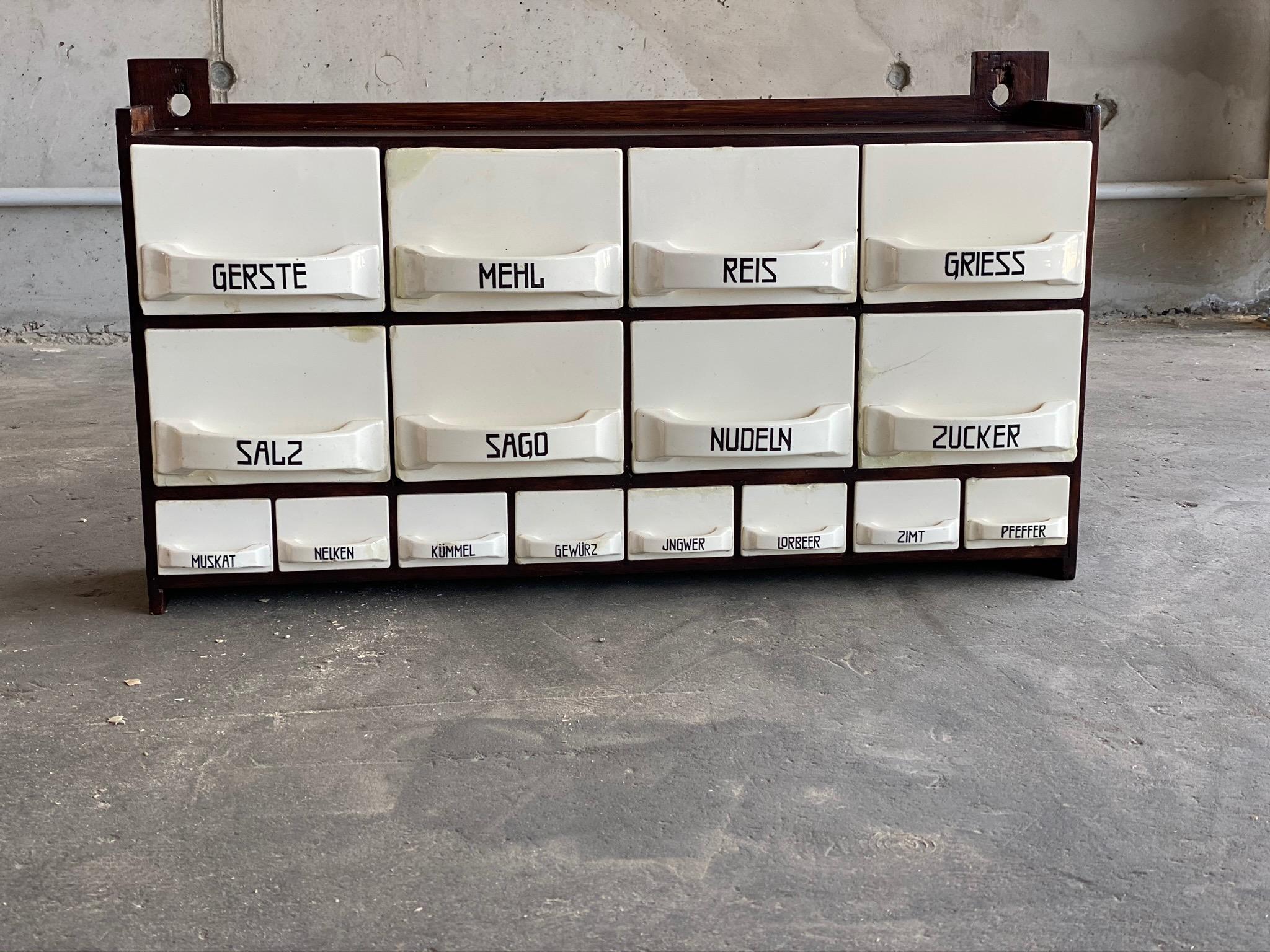 This beautiful antique chute rack is from the time circa 1900 and cuts a fine figure in every kitchen! The differently labeled small and large chutes are made of ceramic and come from the ceramic company Wächtersbach. The shelf is made of wood,