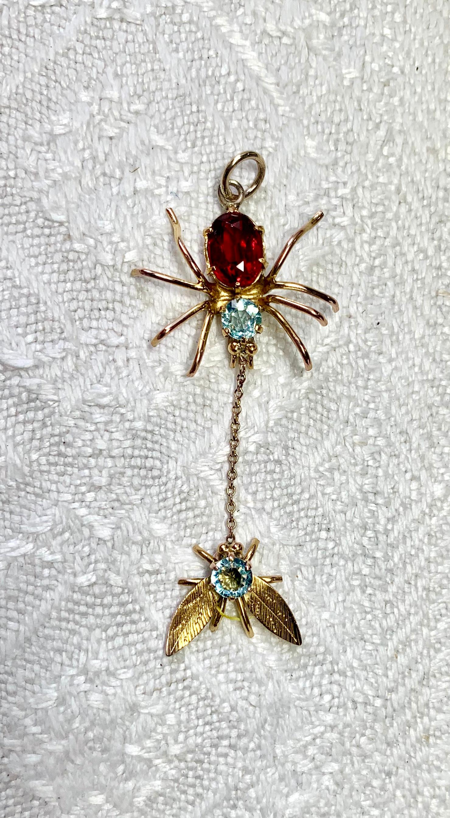 A wonderful antique Art Deco Spider and Fly Pendant set with fine Aquamarine and Garnet gems!  The gorgeous spider and fly are set with two round faceted Aquamarines.  The spider has an oval faceted Garnet body.  The jewels are set in 9 Carat Gold.