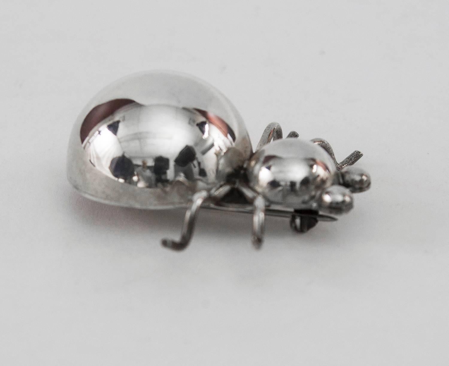 Whimsical spider pin, crafted in sterling silver; featuring four arched silver wire legs, bulbous torso and head and protuberant eyes. Marked: MEXICO STERLING 925. Approx. size:  1.5” long. C1950s. Add a little Pizzazz and your own Unique Style to