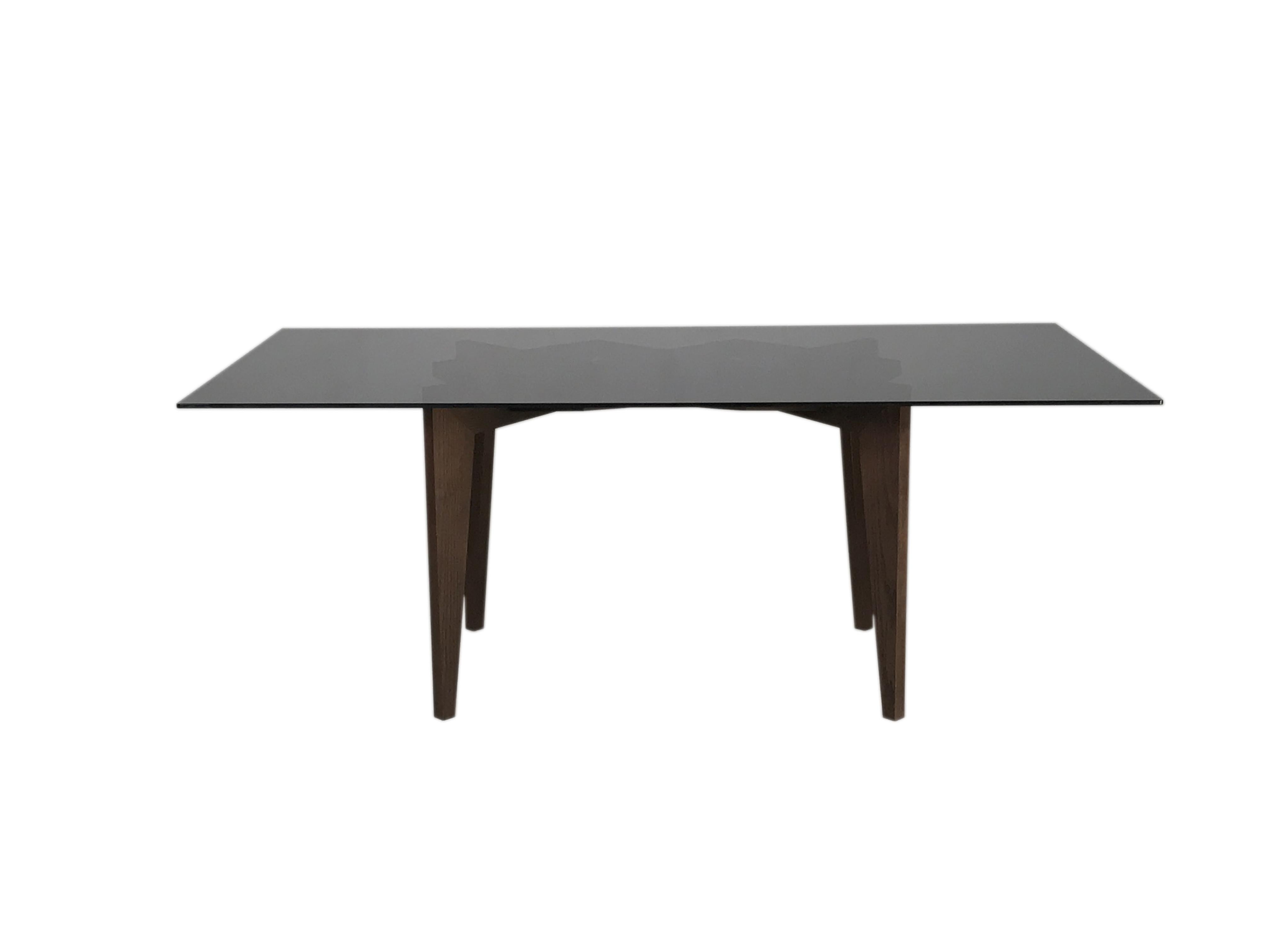 Spider is a contemporary table made of ashwood with interlocking legs made by wooden joints, and glass top.
 