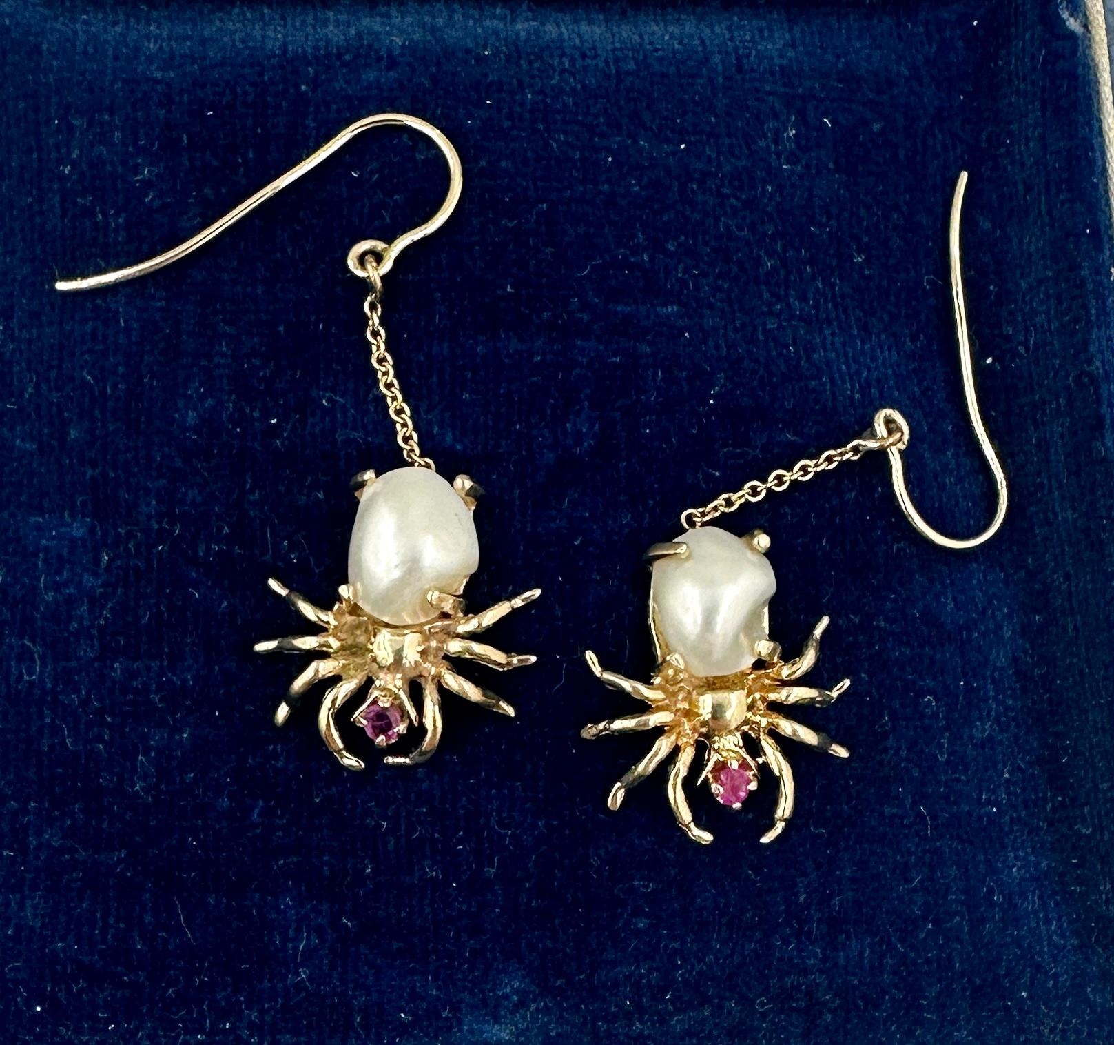 This is a wonderful pair of rare antique Spider Insect Earrings with Pearl bodies and Ruby heads in Yellow Gold.  The spider insect jewels are beautifully made and the dangle drop earrings an absolute delight to wear.  The pearls are exquisite