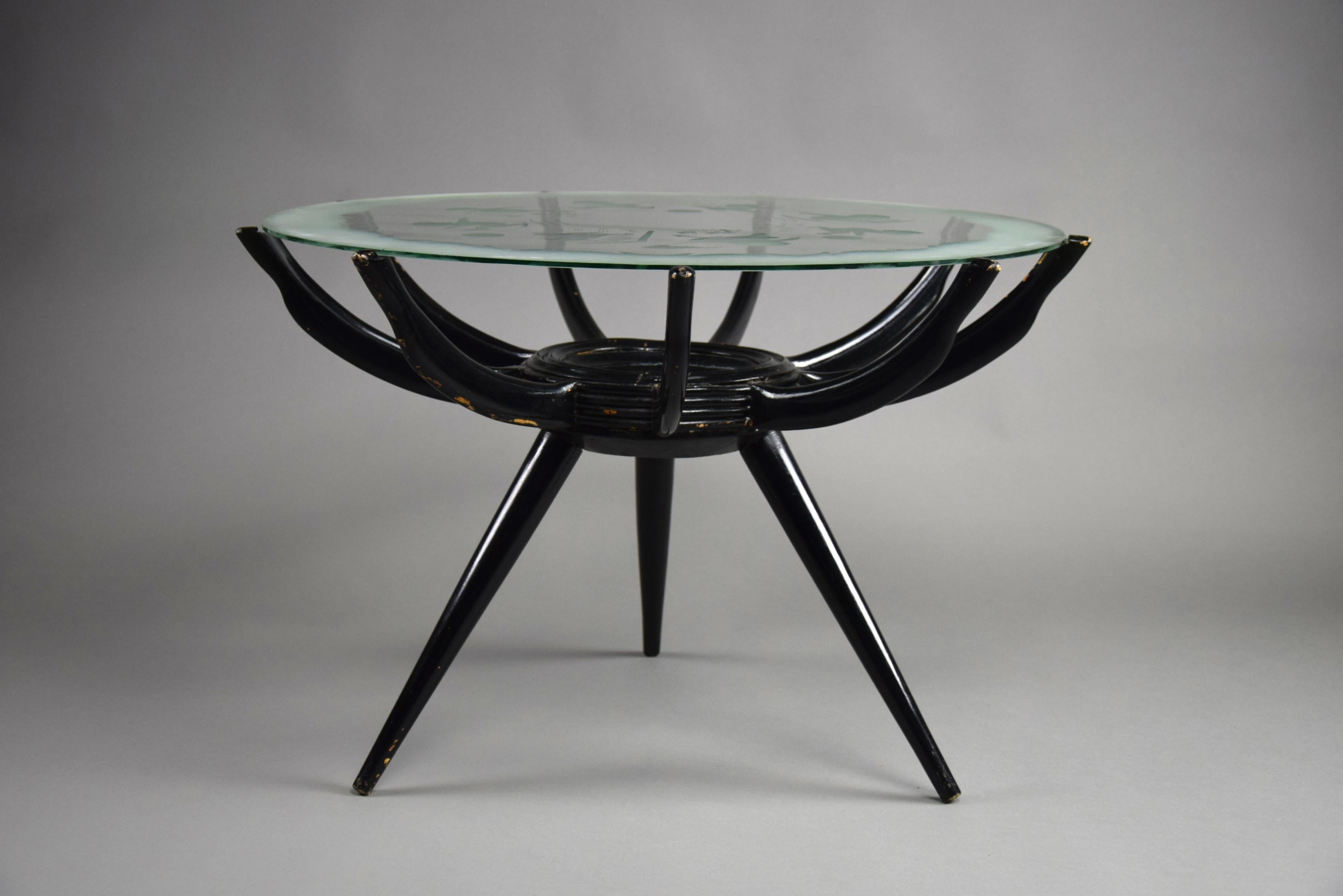 Introducing the timeless elegance of the Spider Leg Coffee Table, a masterpiece designed by Carlo de Carli in the iconic 1950s era. With its striking black painted wooden three-legged base, adorned with nine meticulously crafted bent wooden arms,
