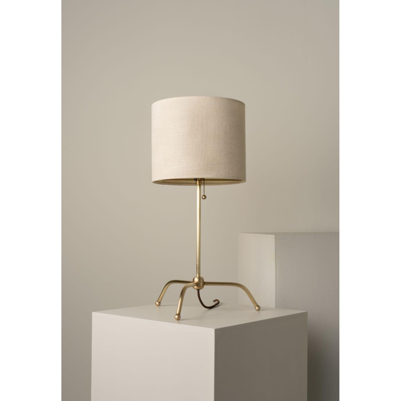 Spider Long Legs Table Lamp by Isabel Moncada
Dimensions: Ø 35.5 x H 66 cm.
Materials: Forged and brushed brass and linen-lined fiberglass lampshade.

Short, discreet, and stable legs. Their strength is lightness. The Ivory linen lets through