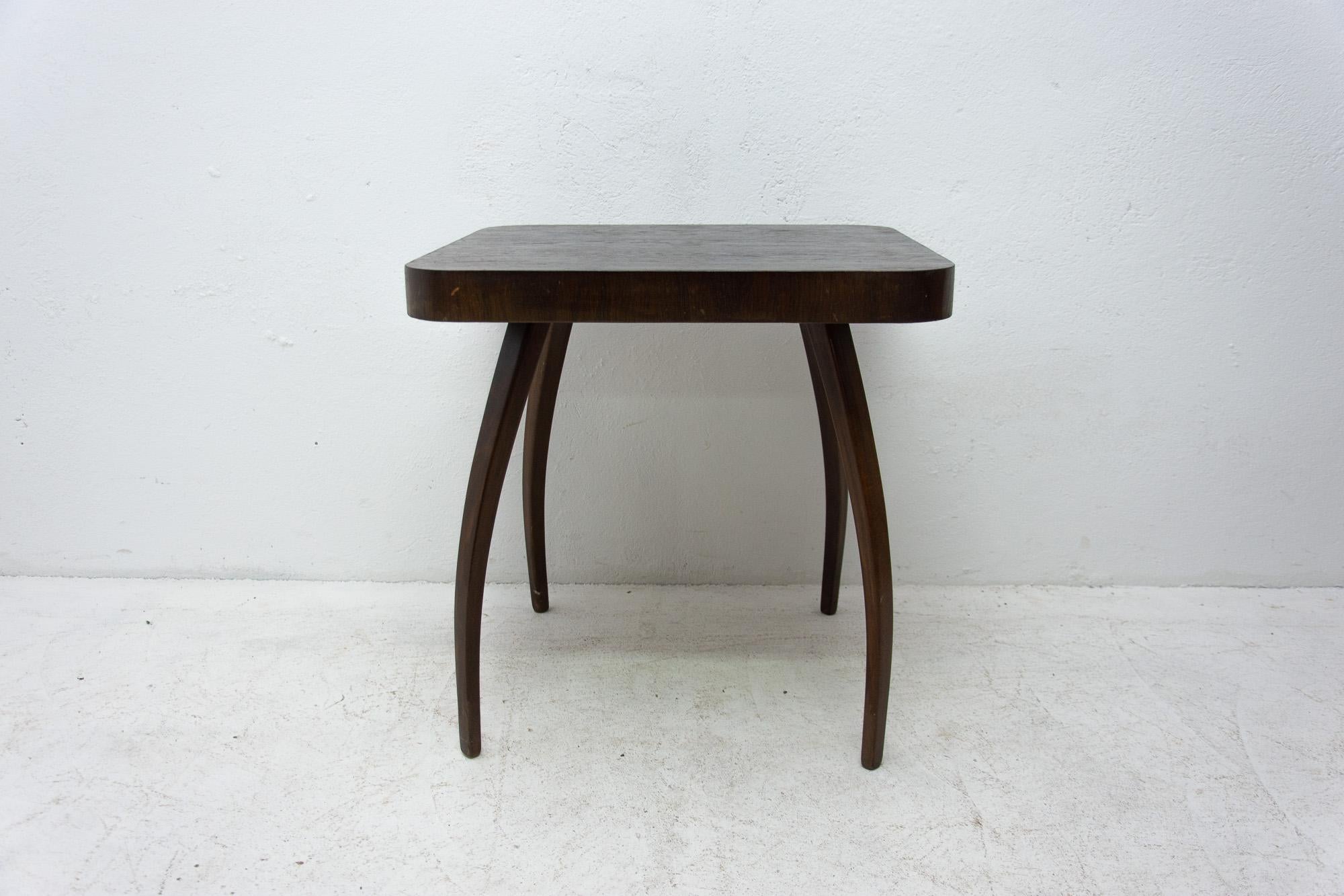 A Popular square coffee table in the shape of spider designed by Jindrich Halabala circa 1930s, with distinctive curved legs, rounded corners. Stained oak. In good original vintage condition, shows signs of age and using.