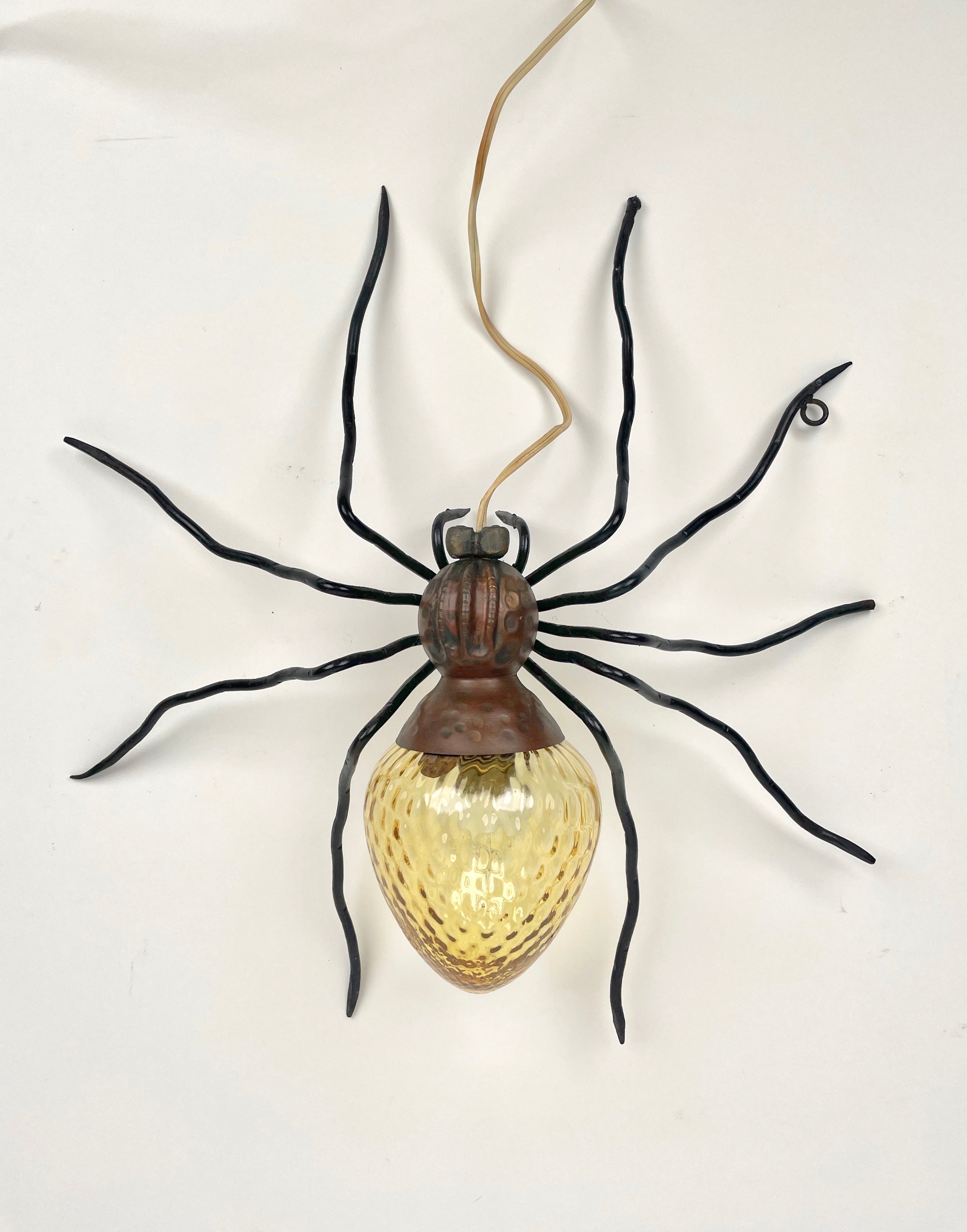 Spider wall lamp sconce in copper, iron and yellow art glass made in Italy in the 1960s. 

This lamp is a typical outdoor lamp mounted over the entrance door of Italian houses of the 1960s. 

Nowadays they are requested design objects to be used