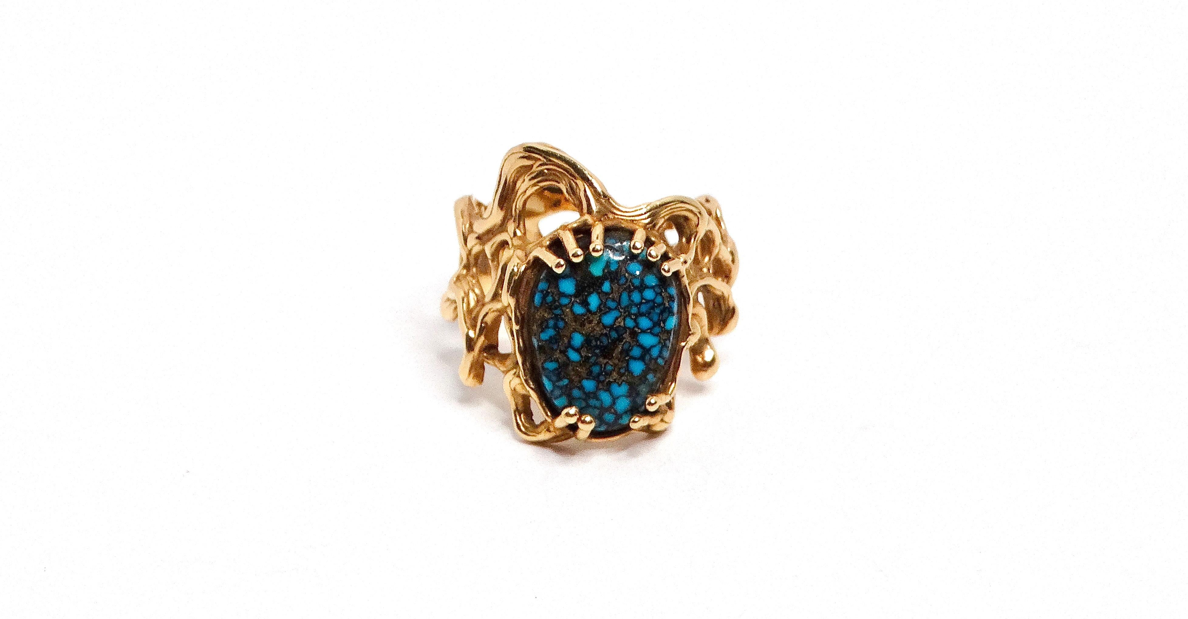The Spider Web Turquoise 14k Gold Ring is a striking piece of jewelry that beautifully combines nature-inspired design with fine craftsmanship. The genuine turquoise stone, set at the center, features the characteristic veining that resembles a