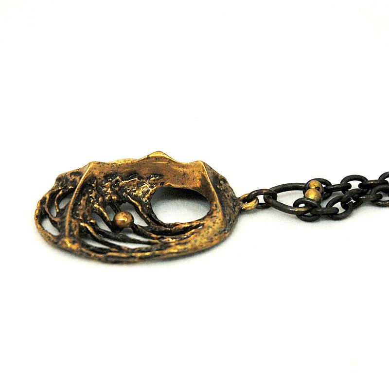 Lovely bronze pendant with original bronze chain by designer Karl Laine for Sten & Laine -Finland 1970s. The pendant has a combination of melted look and spider web design. Natural bronze patina with. Good vintage condition. Signed KL.
Size of