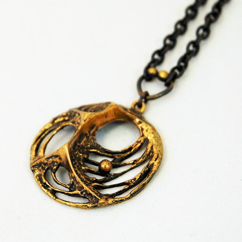 Lovely bronze pendant with original bronze chain by designer Karl Laine for Sten & Laine -Finland 1970s. The pendant has a combination of melted look and spider web design. Natural bronze patina with. Good vintage condition. Signed KL.
Size of