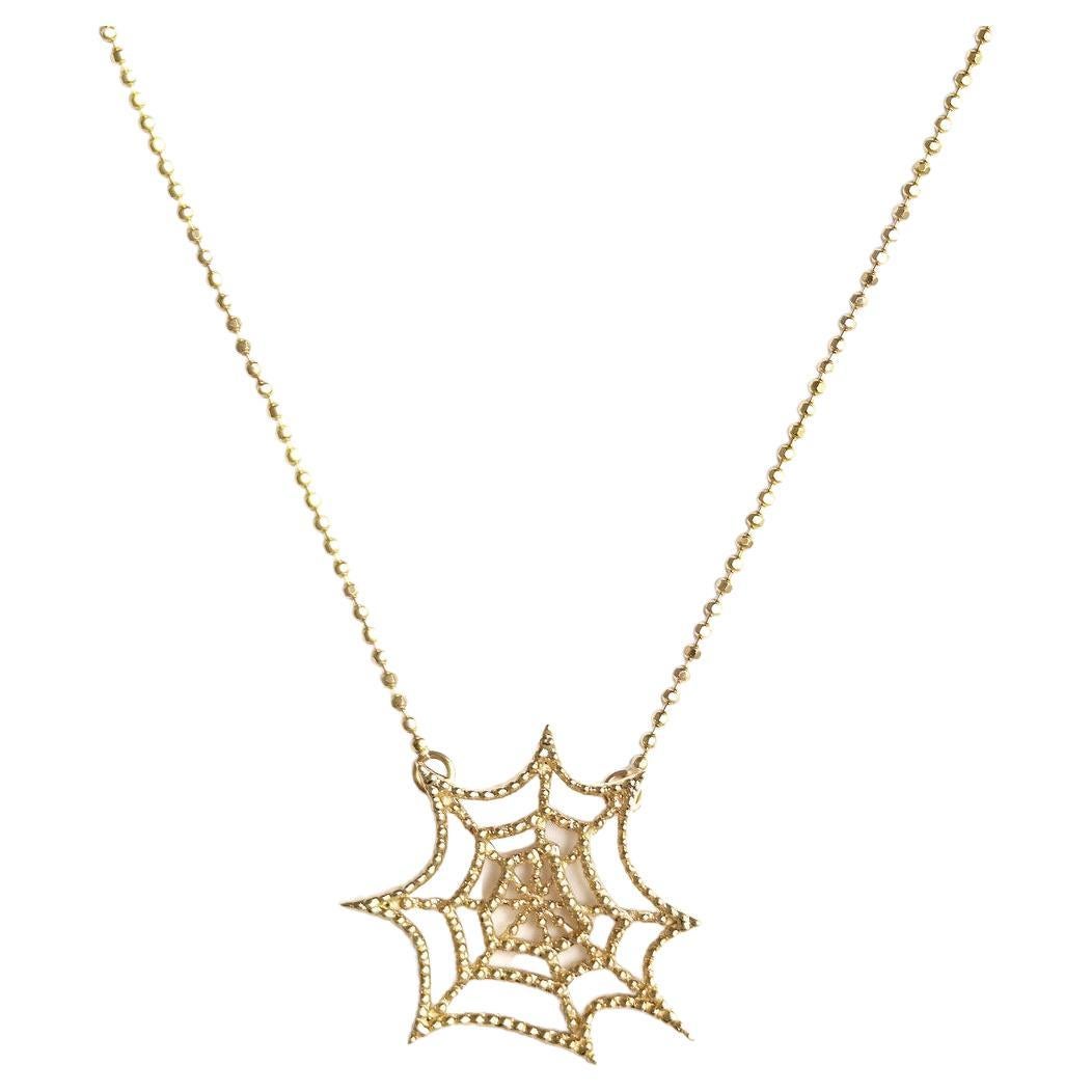 Discover the captivating beauty of our Spiderweb Necklace in Yellow Gold Plating. Crafted with delicate precision, this limited edition piece showcases the allure of a spider's web—fragile, yet highly effective.

The necklace features a finely