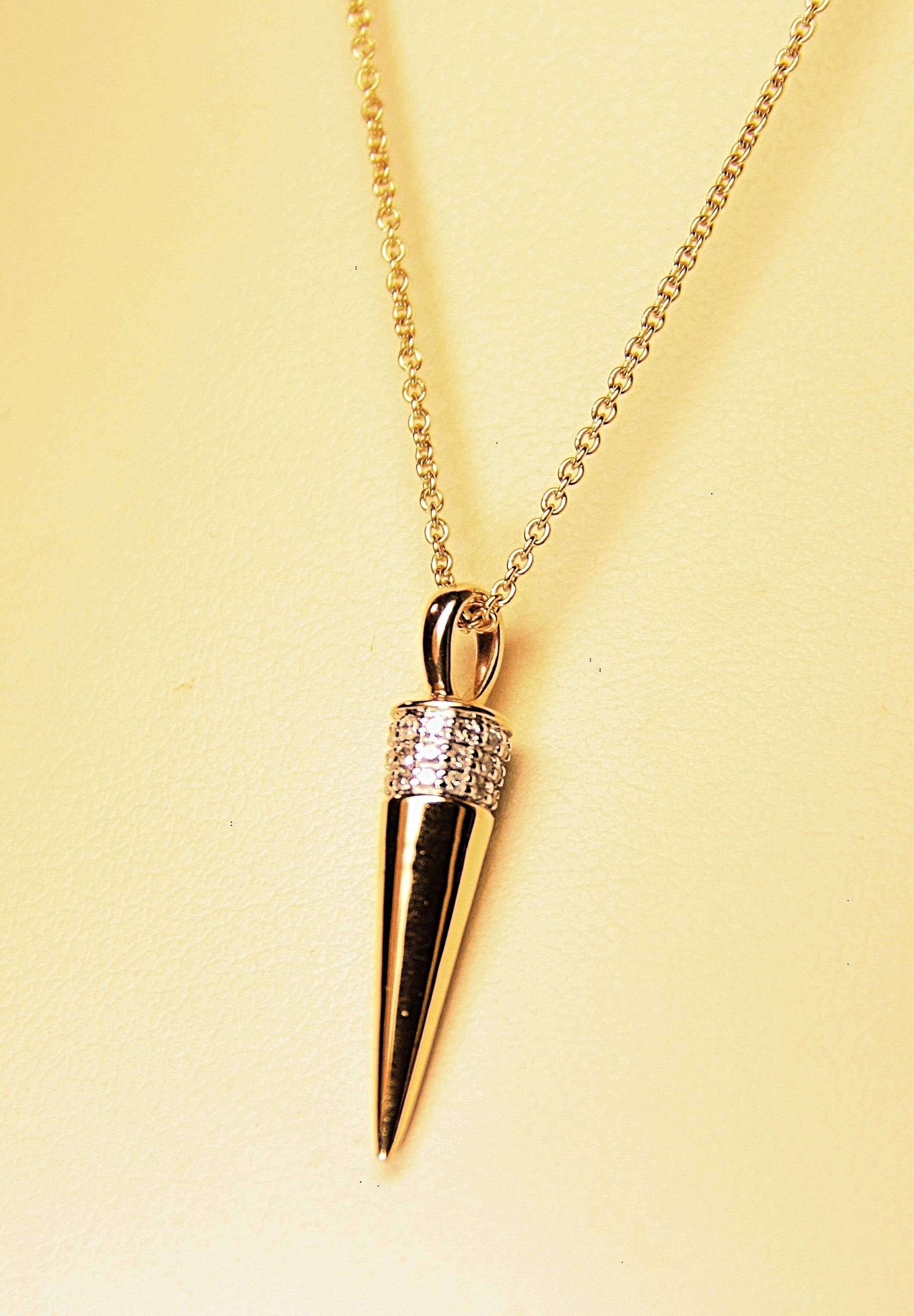 A spike designed (solid gold) pendant on a 14K Yellow Gold chain.  Spike pendant is circled at the top with diamonds that weigh .20 carat total weight.  The charm pendant chain is 18 inches long and 1 mm wide. The spike is 1 inch long and 5 mm at