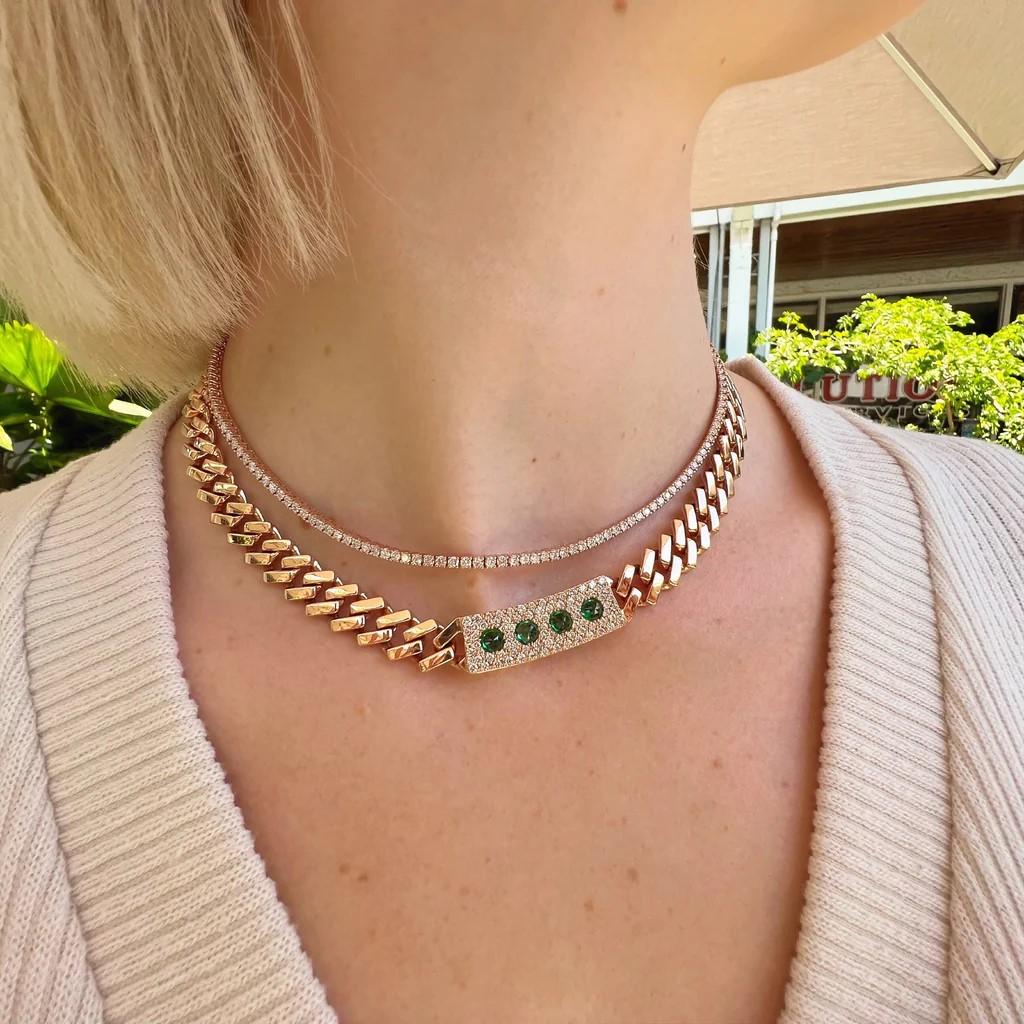 Make a statement with the unique Emerald Spiked 18kt rose gold Cuban link necklace held extravagantly by F color VS clarity diamonds totaling 1.38 carats.

Length is 16 inches. It is approximately 1 cm wide.