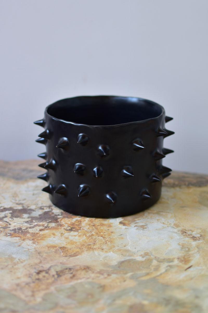 Beautiful ceramic handmade planter. Carefully crafted, each black ceramic plant pot is thrown and trimmed on the wheel, and every outer spike is individually attached by hand. Finished with a hand-applied satin black glaze.

As a result, each