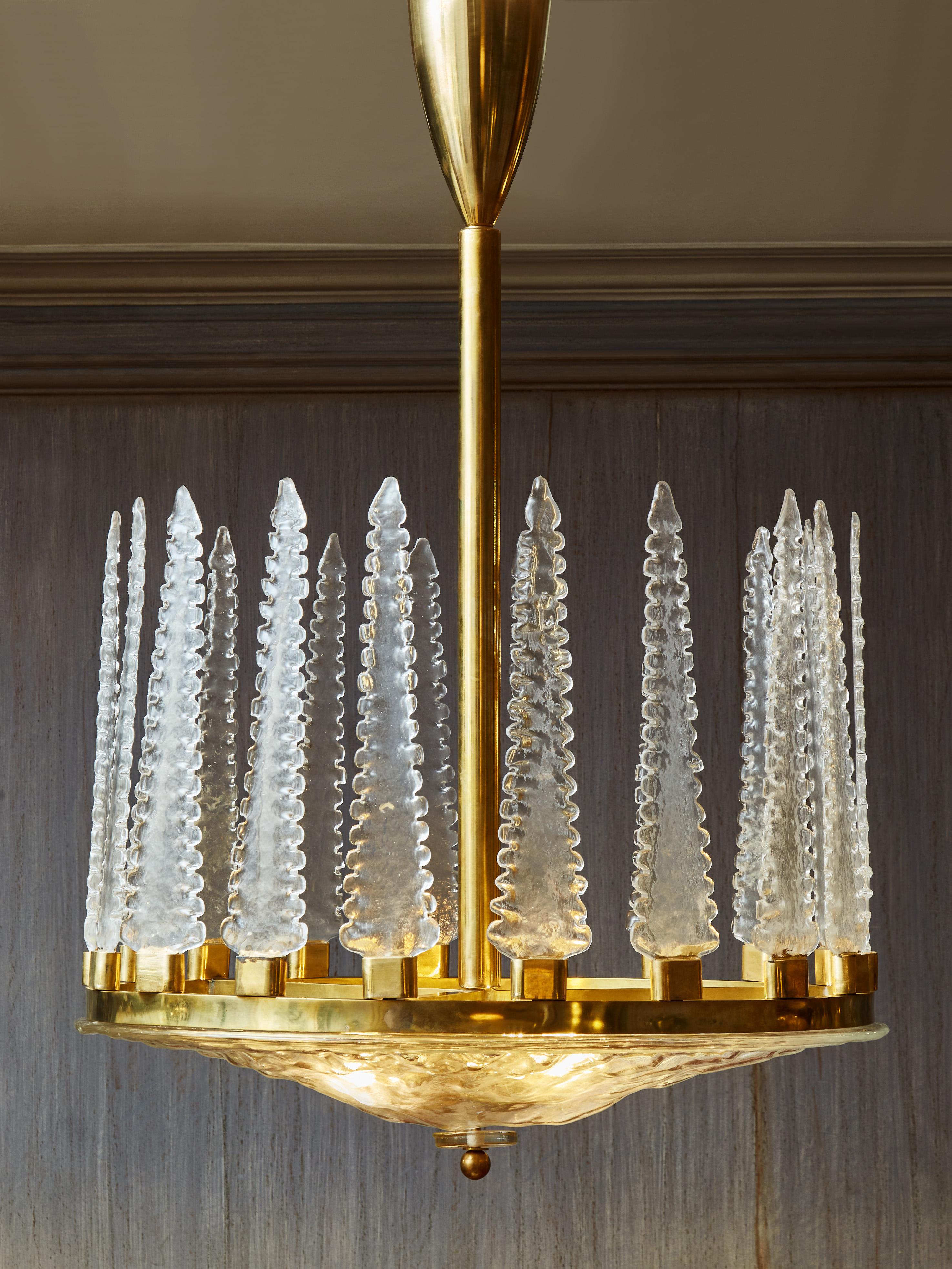 Superb chandelier in sculpted Murano glass and brass. 
Creation by Studio Glustin.