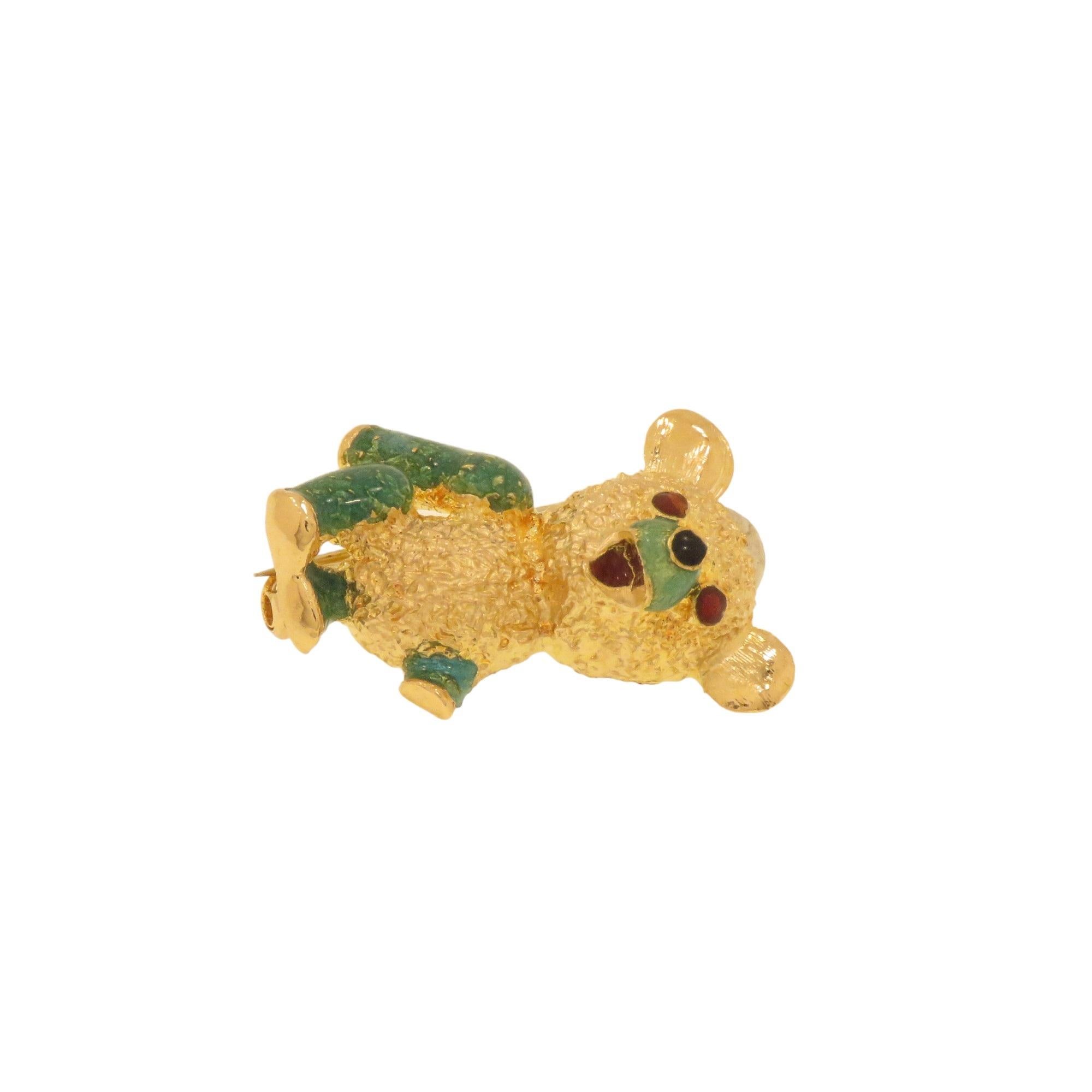 Pretty brooch depicting a teddy bear handmade in 18K gold between 1960 and 1970. Attention to mini details, The body is hand-engraved and the paws, muzzle and eyes are fire enameled. The measurements of the brooch are 26x20 mm / 1.023x0.787 inches.