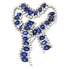 White gold knot brooch with sapphires and diamonds