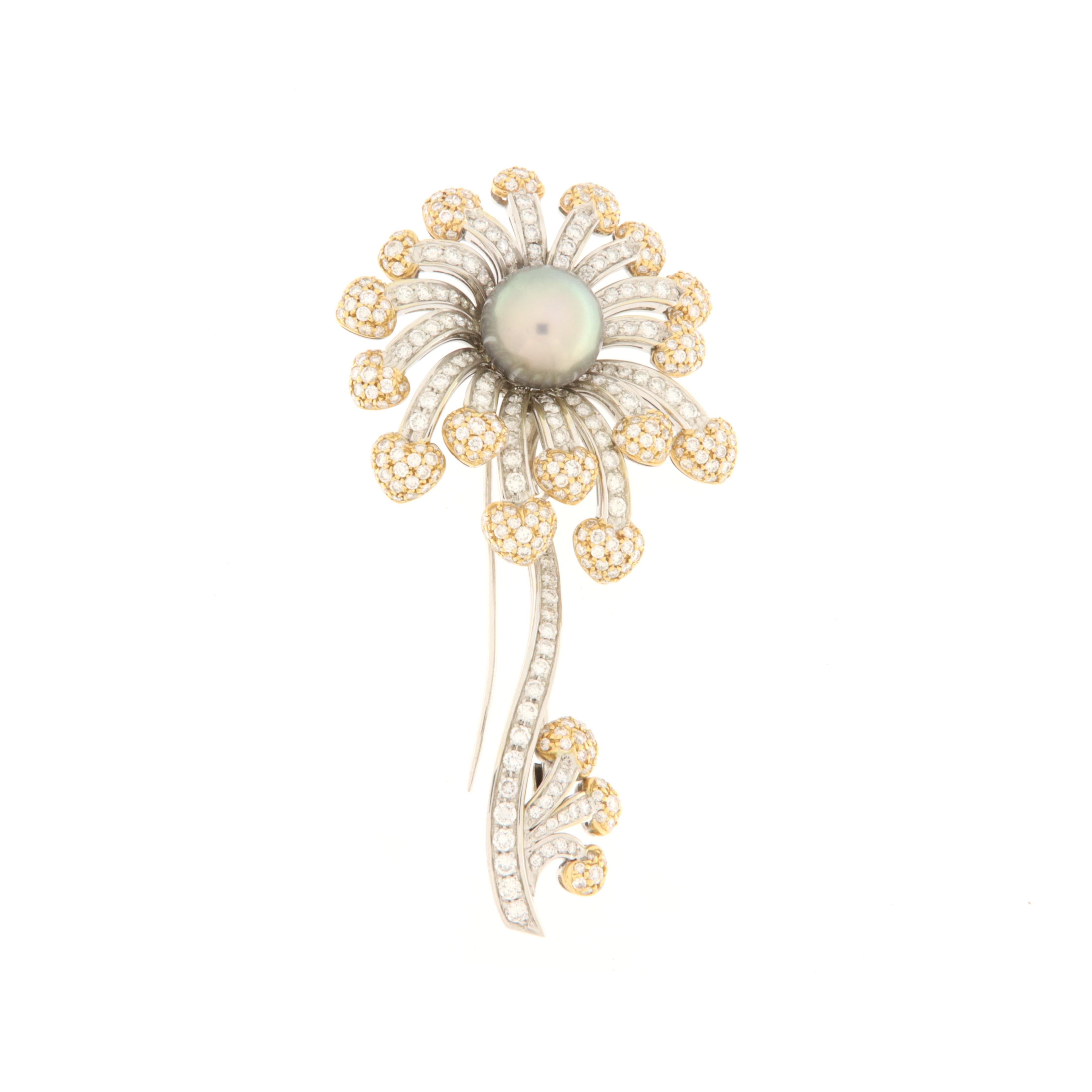 Important flower-shaped brooch with 12mm. Tahitian pearl pistil and petals made with sagging hearts in white and yellow gold with diamonds. The stem and leaves are also made of white and yellow gold with diamonds. The total carat of the brilliants