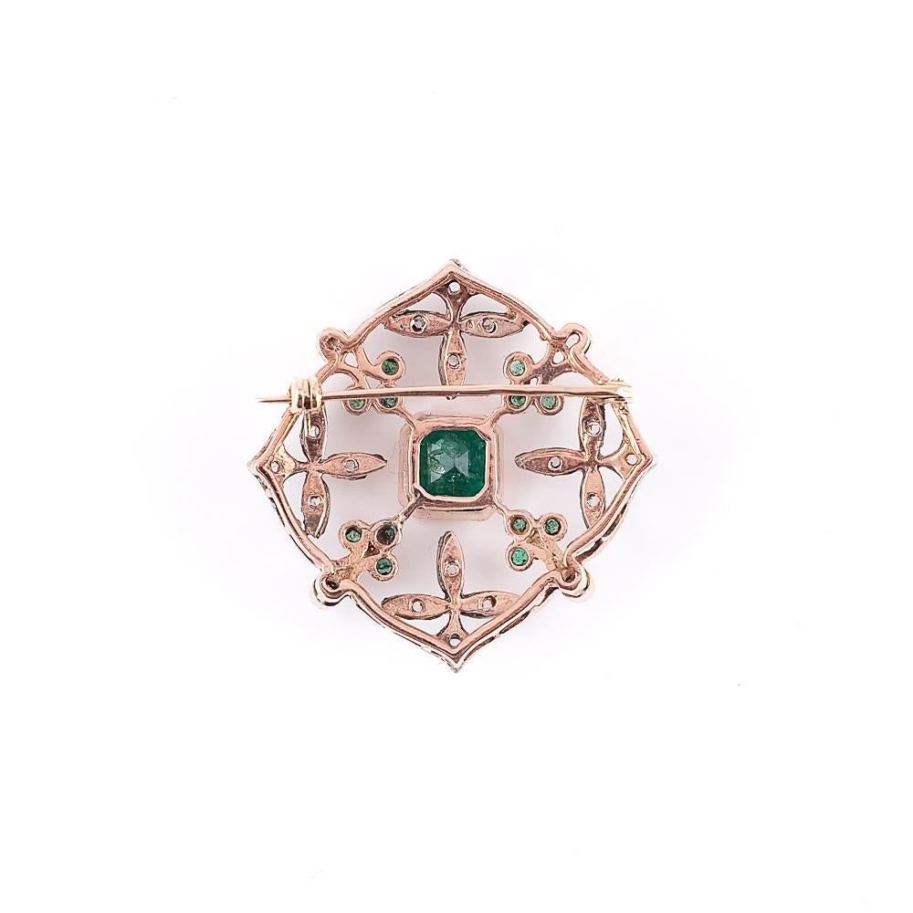 An extraordinary gold brooch, masterfully designed to celebrate timeless elegance. Antique rose-cut diamonds, enchanting in their romantic and delicate light, add a touch of historical sophistication. Emeralds, in a deep, vibrant green, complete the
