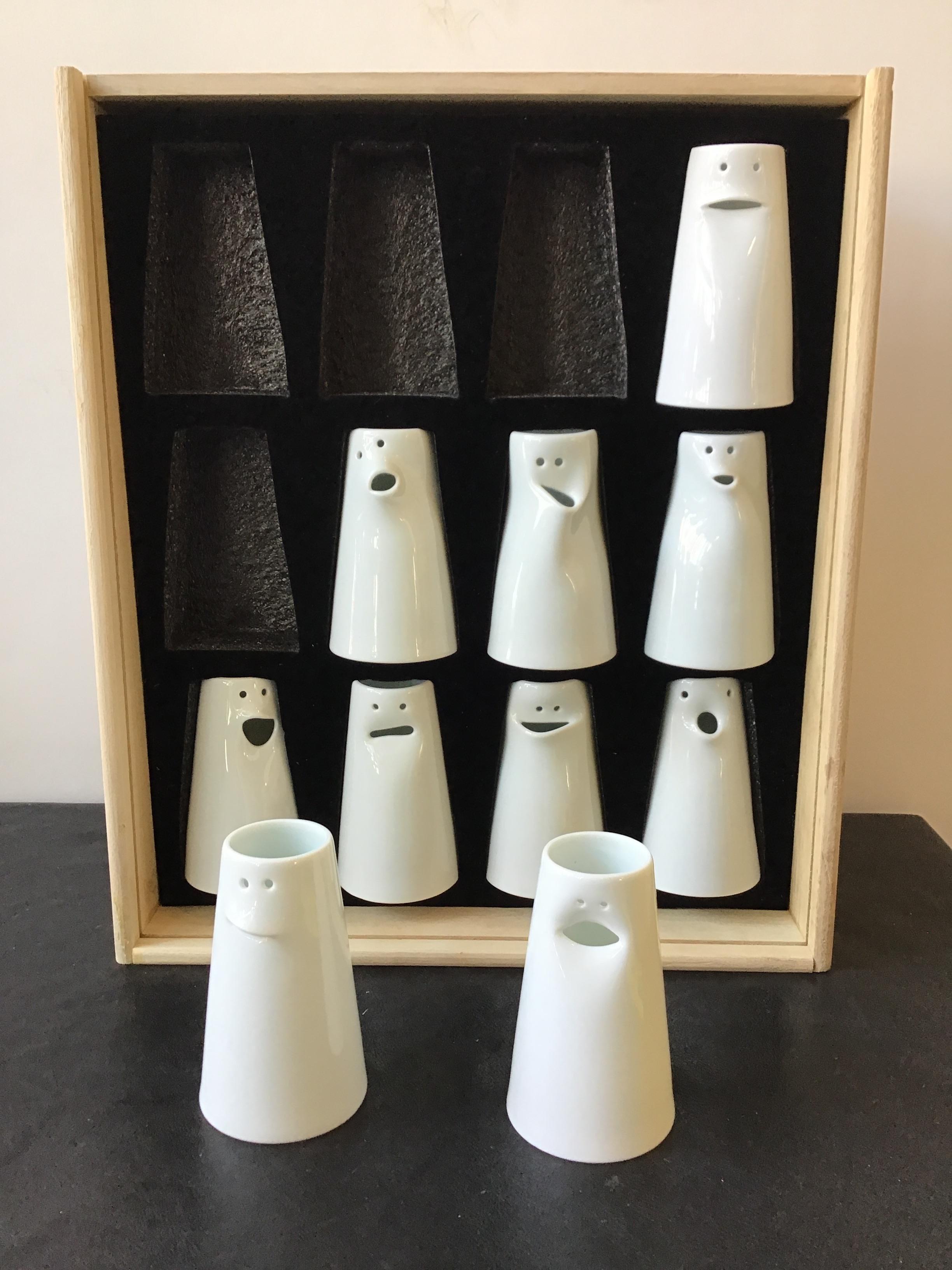 Spin ceramics fine porcelain face bud vases, designed by Tong Wei. Made by Jingdezhen. Some vases can also be used as creamers. Each face is different. Set of 10.