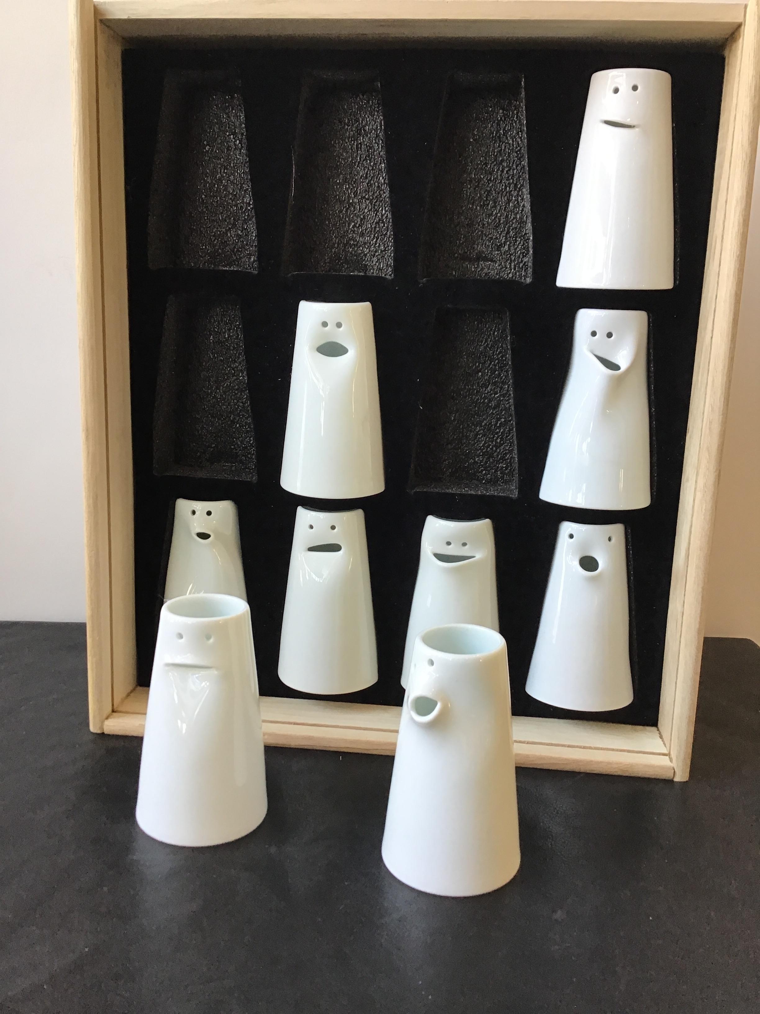 Spin ceramics fine porcelain face bud vases, designed by Tong Wei. Made by Jingdezhen. Some can be used as creamers. Each face different. Set of 9.