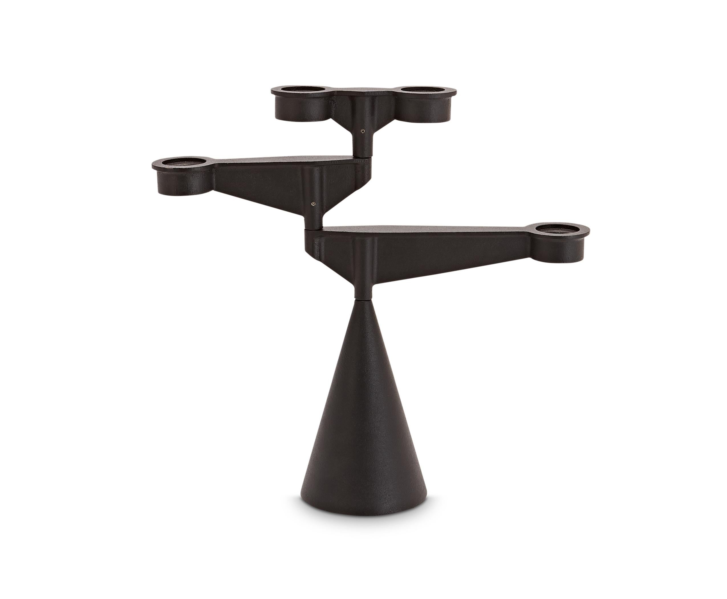 An industrial-strength piece of table-top engineering designed to act as a kinetic centrepiece and produce infinite arrangements. Able to hold tea lights and taper candles with equal elegance, the cast iron contraption takes cues from the