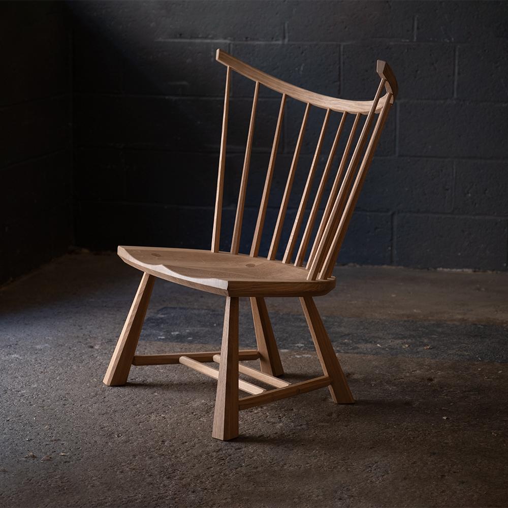 Handmade contemporary spindle back windsor lounge chair made in oak by furniture makers Bibbings & Hensby. 

The posture of the chair is relaxed with a generous recline and wide seat. Each component of the chair is shaped by hand using traditional