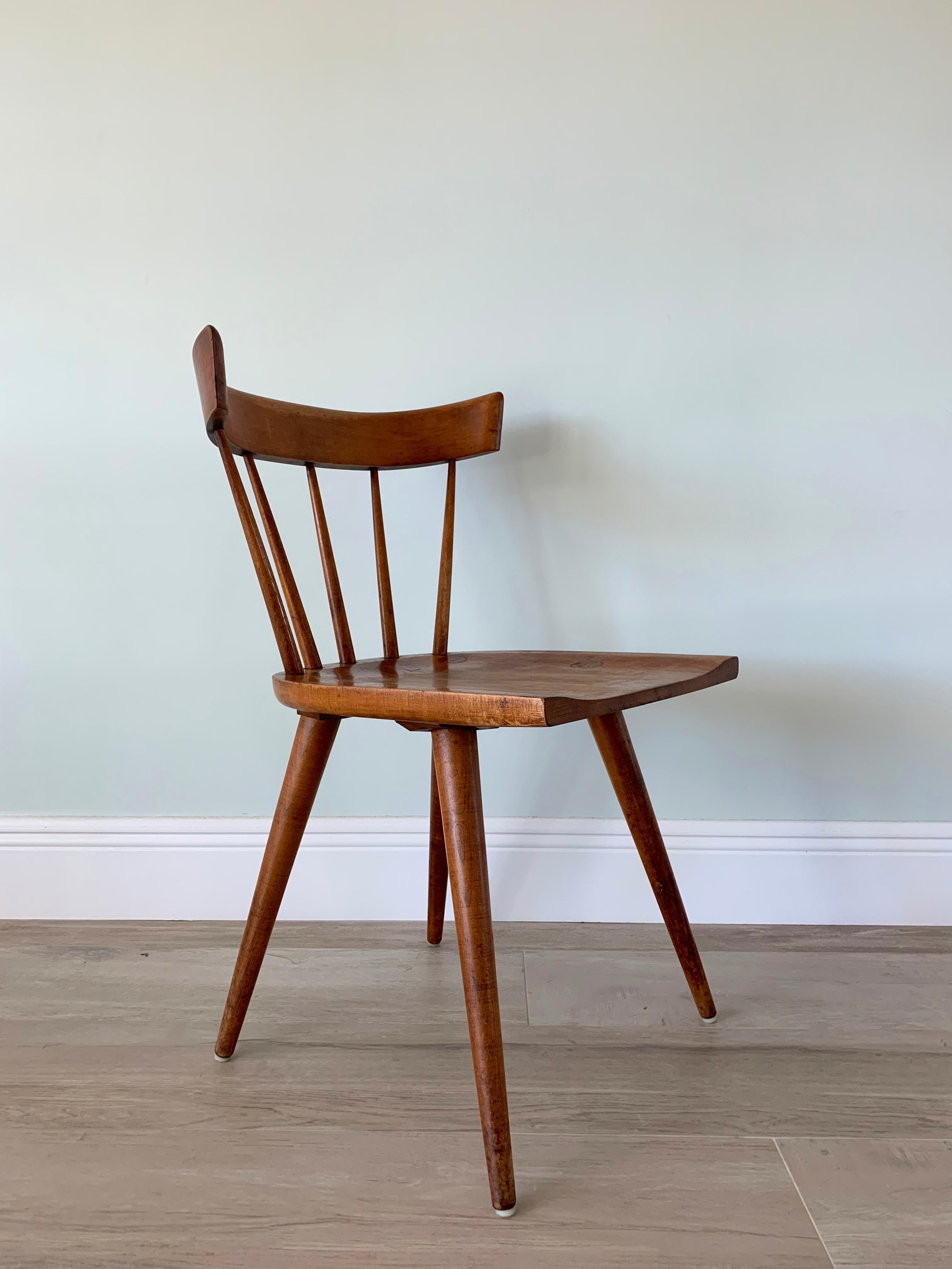 Maple spindle back dining chair from the Planner Group series designed by Paul McCobb and manufactured by Winchendon, Massachusetts. 
Good condition with a fantastic patina.