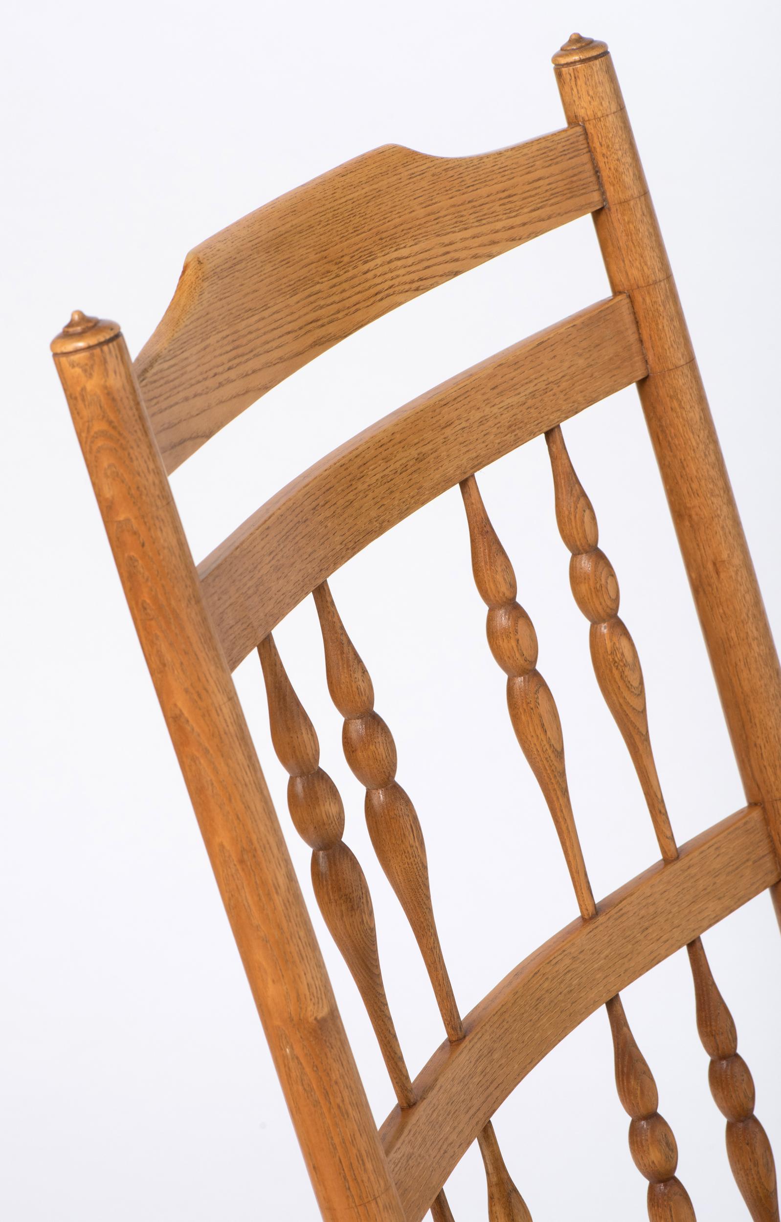 Early 20th Century Spindle Back Rocking Chair with Rush Seat by Neville Neal, England circa 1920 For Sale