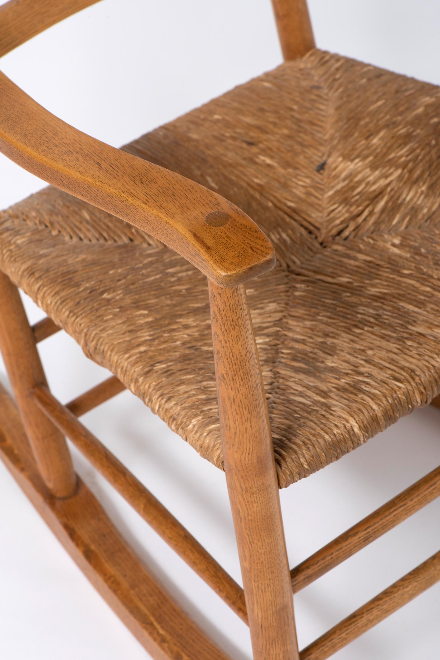 Spindle back Rocking Chair with rush seat by Neville Neal, England circa 1920. For Sale 1