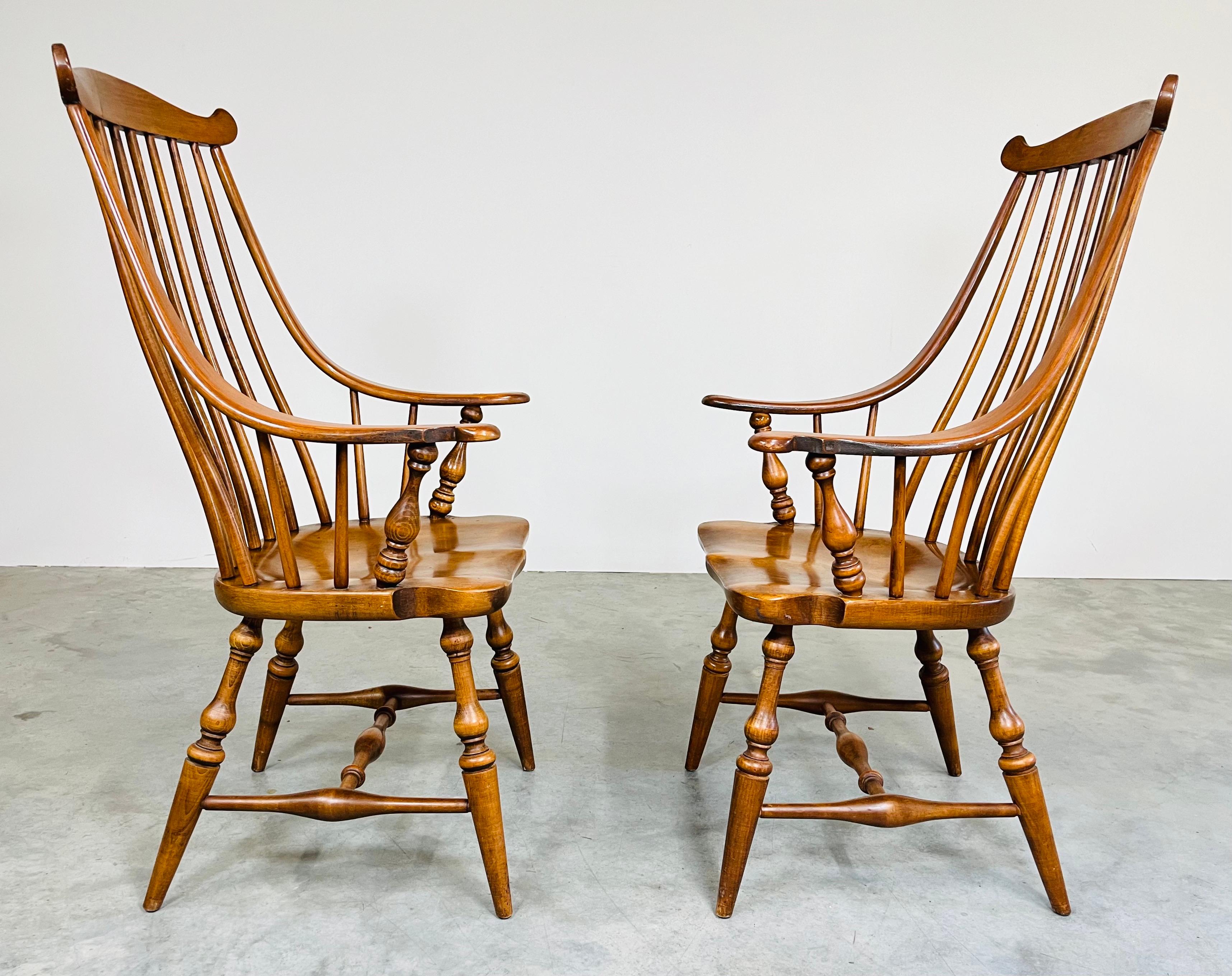 A pair of Windsor armchairs by Heywood Wakefield in the Georgian style having spindle backrests with fan tops. 
North America circa 1950. In excellent condition having solid frames and beautiful finish. 
43.5x24x25” HWD SH 17”