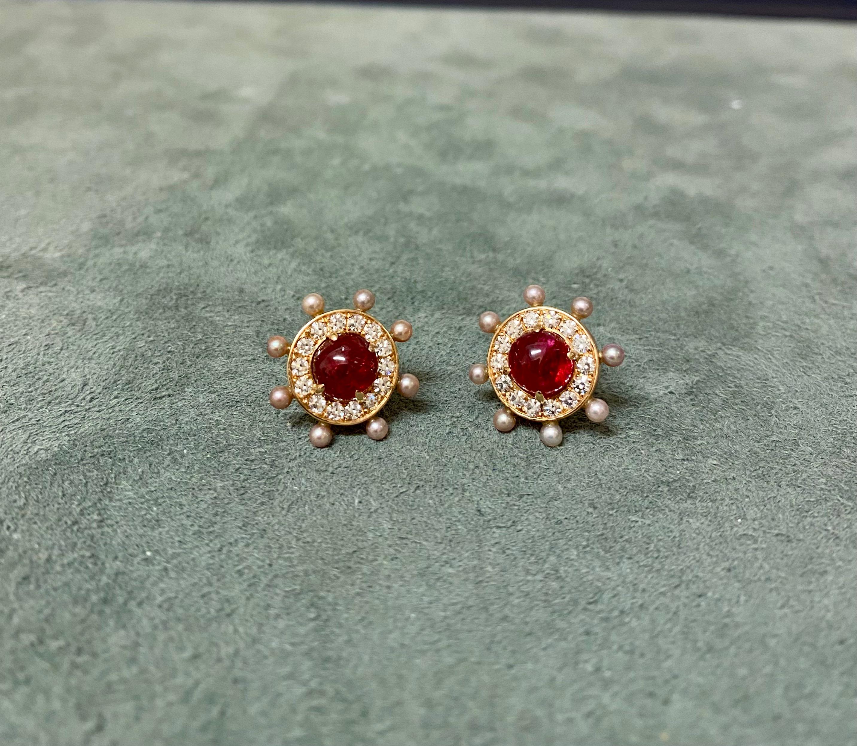Two red cabochon cut spinels set in 18k red gold, with diamonds and natural pearls. The spinels weigh a total of 3.98cts, the 16 natural pearls 1.46cts, and the 28 single cut diamonds weight a total of 0.61ct. 