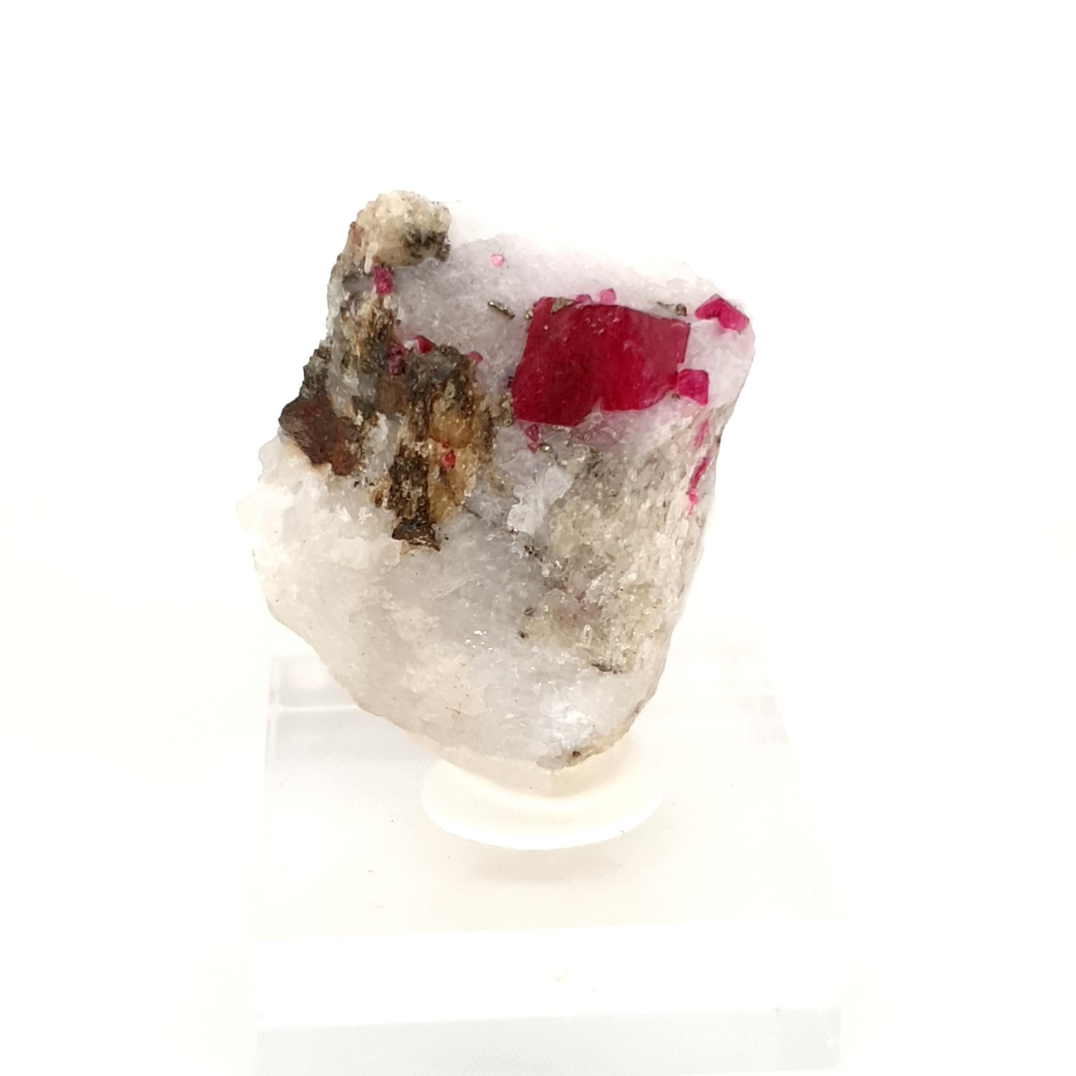 These Specimen exhibits an incredible rich saturated red hue in the form of small octaeder embedded in a matrix of grayish white Calcite.
The contrast with the cluster of well-formed vivid red spinel octahedra is striking.

measures: 28x18x34