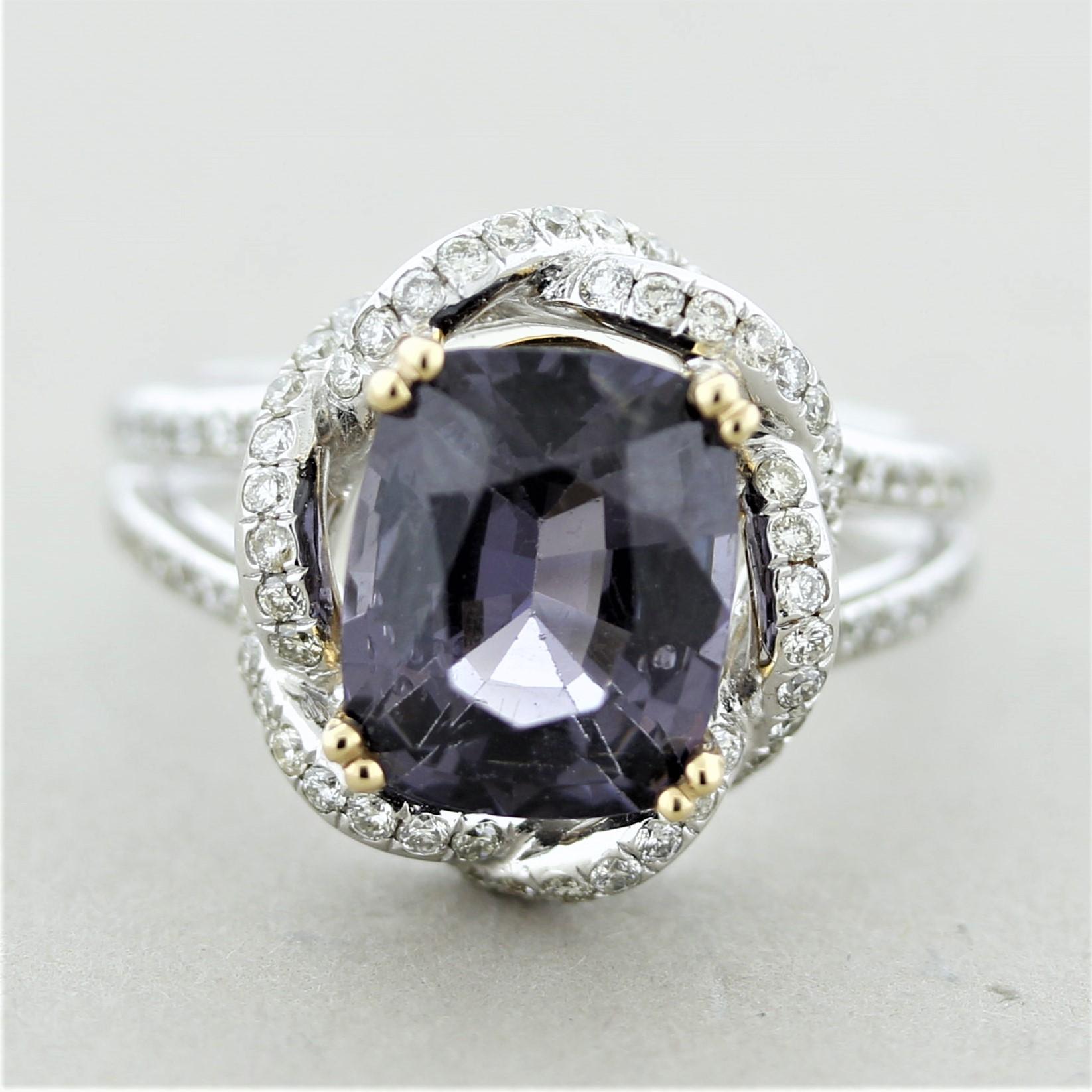 An impressive and stylish ring featuring a 4.31 carat cushion-shaped spinel. It has a soft metallic purple color that is bright and clean. It is accented by 0.74 carats of round brilliant-cut diamonds set spiraling around the spinel and down the