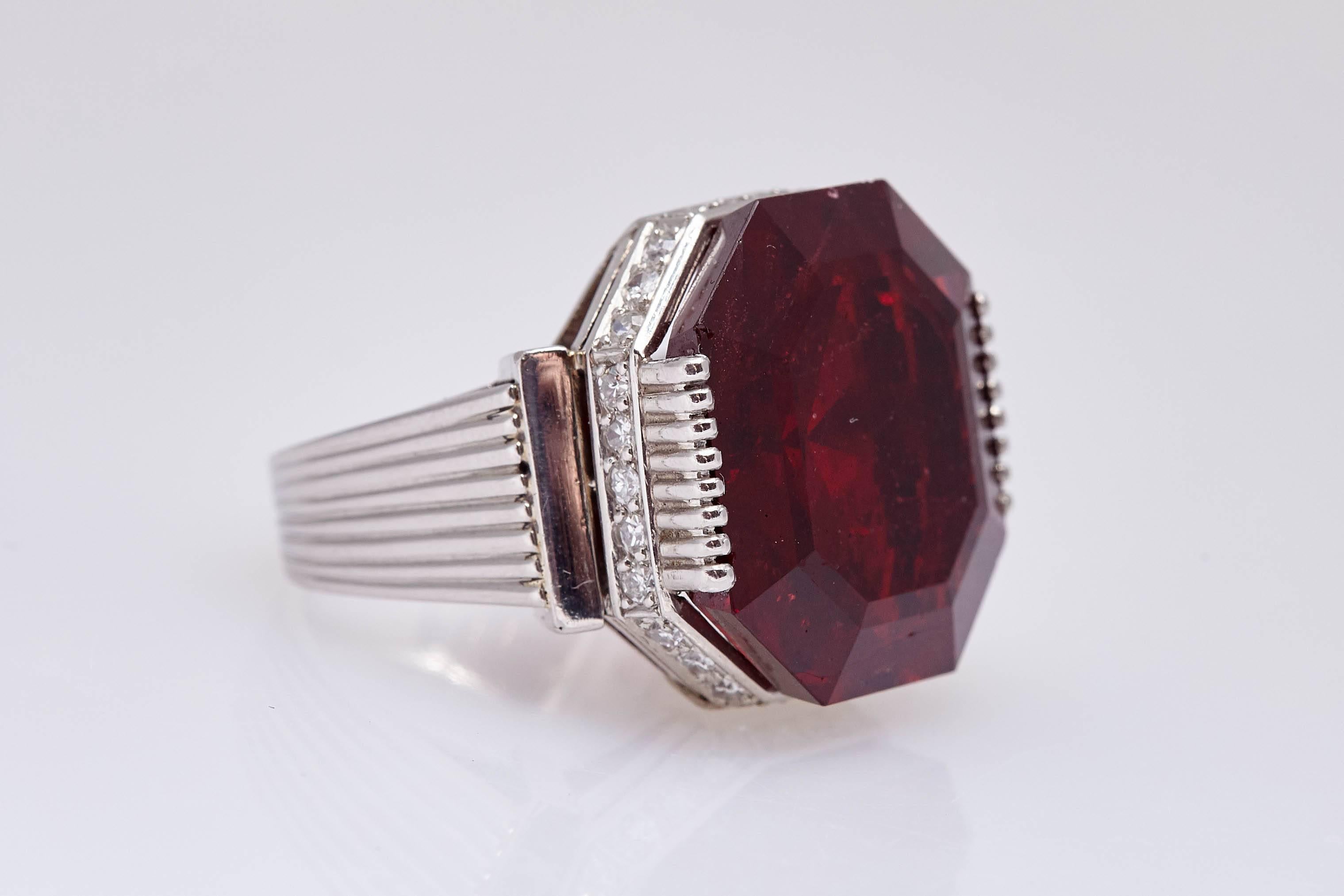 A ring in platinum showcasing a spinel of exceptional color (octagonal step cut, 22.08 cts) and 30 old cut diamonds (total weight app. 1 ct). Spinel is AGL certified as natural. Mounted on platinum (Stamped Pt 950). Made in Italy, circa 1980