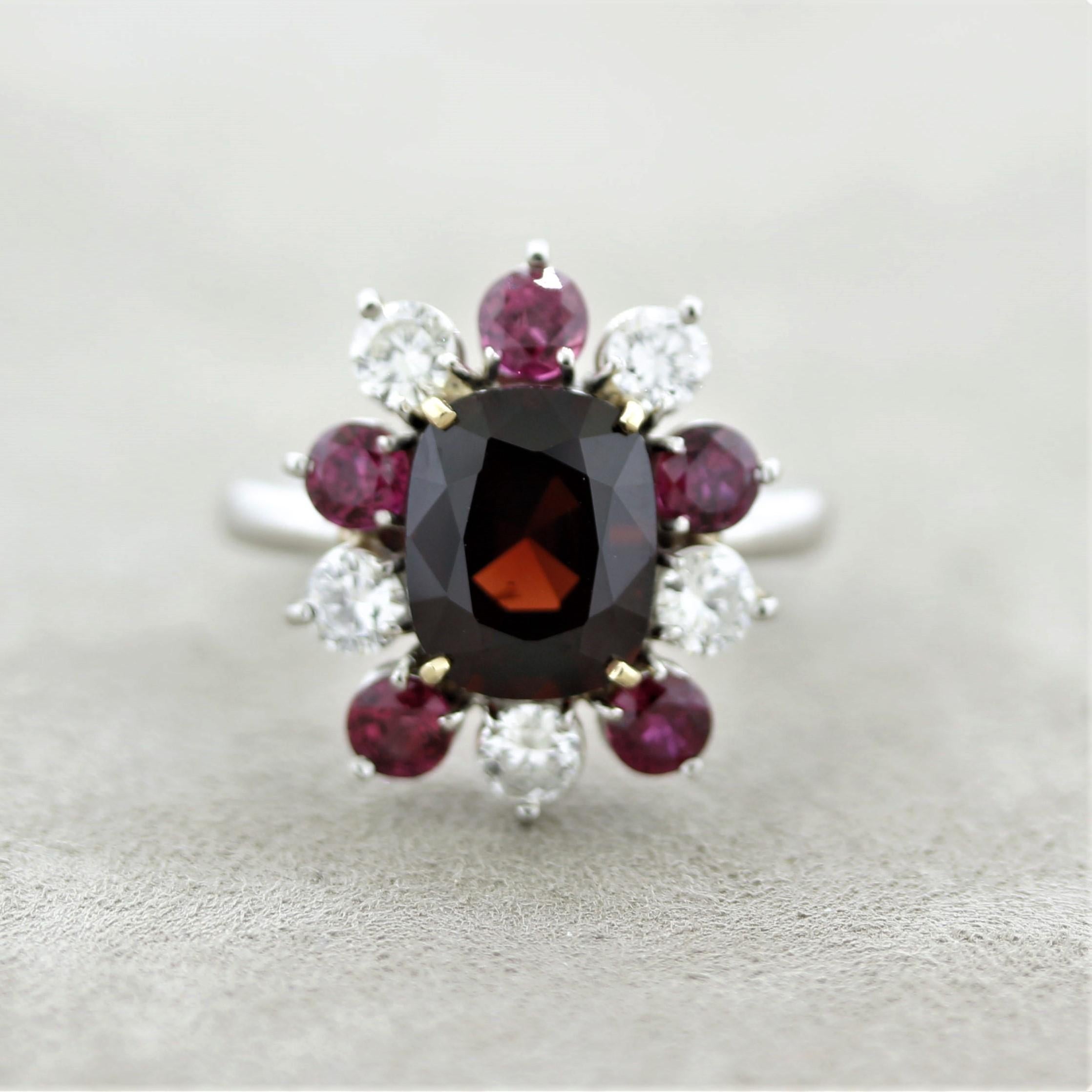 A rich deep red spinel weighing 3.84 carats takes center stage! It has a lovely cushion shape and is certified by the GIA as natural with no treatments of any kind. It is accented by round-cut diamonds and rubies which run around the spinel weighing