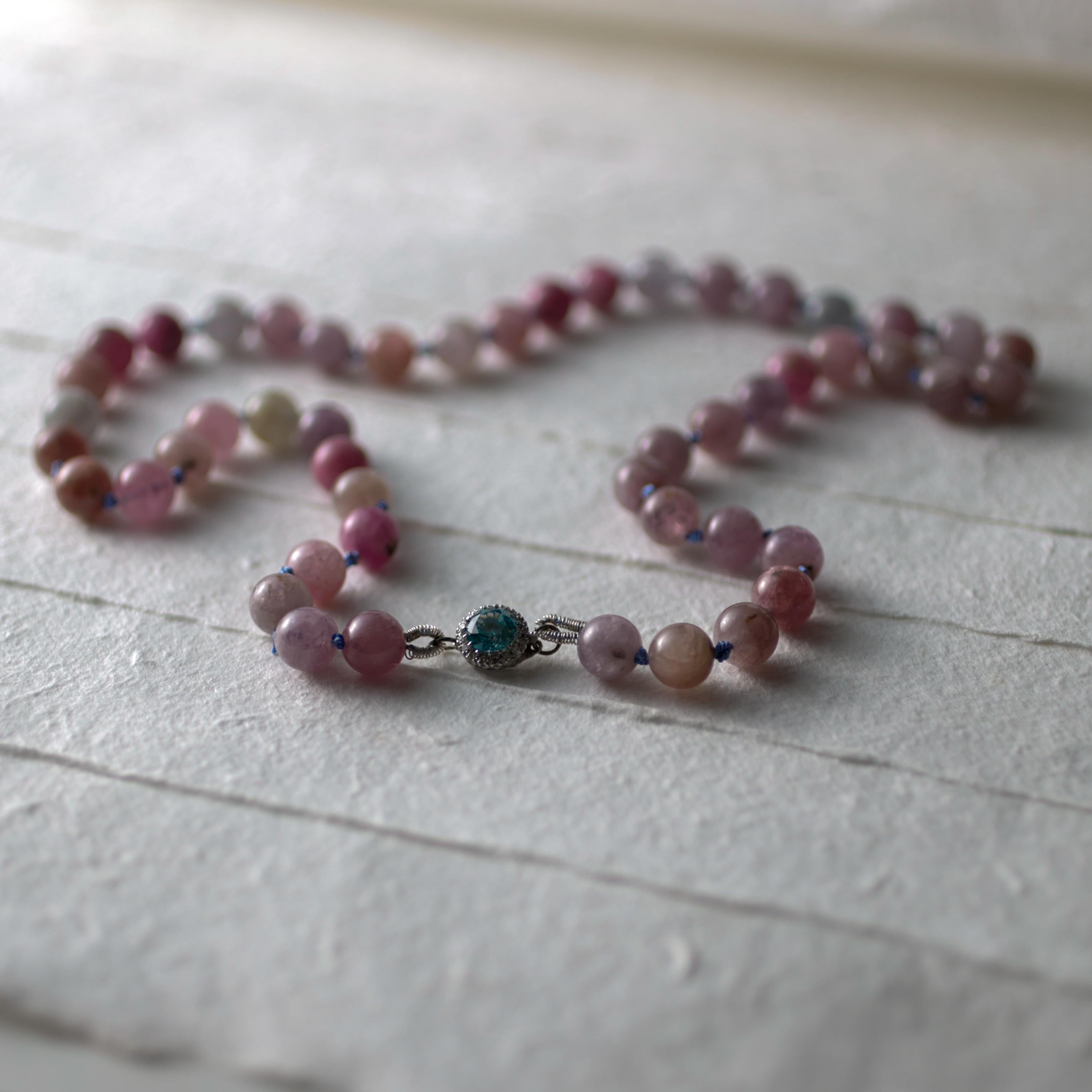 A stunning and entirely unique unworn necklace made with 49 natural and certified unheated spinel beads in soft shades of pink, lavender-gray, light purple, soft copper, and raspberry red. The nuanced palate of these beads is perfectly complimented