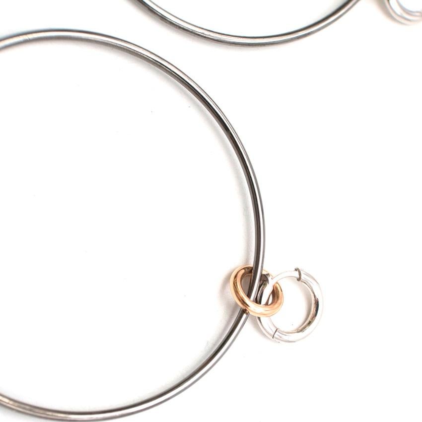 Spinelli Kilcollin altaire hoop earrings

The Altaire hoop earrings are comprised of 57mm drop hoops connected by 18k links to our 18k Micro Hoop closure

- Hoops- 1.5 mm gauge hoop, 57mm  
- Link-  18k gold 
- Micro Hoop- 18k gold,