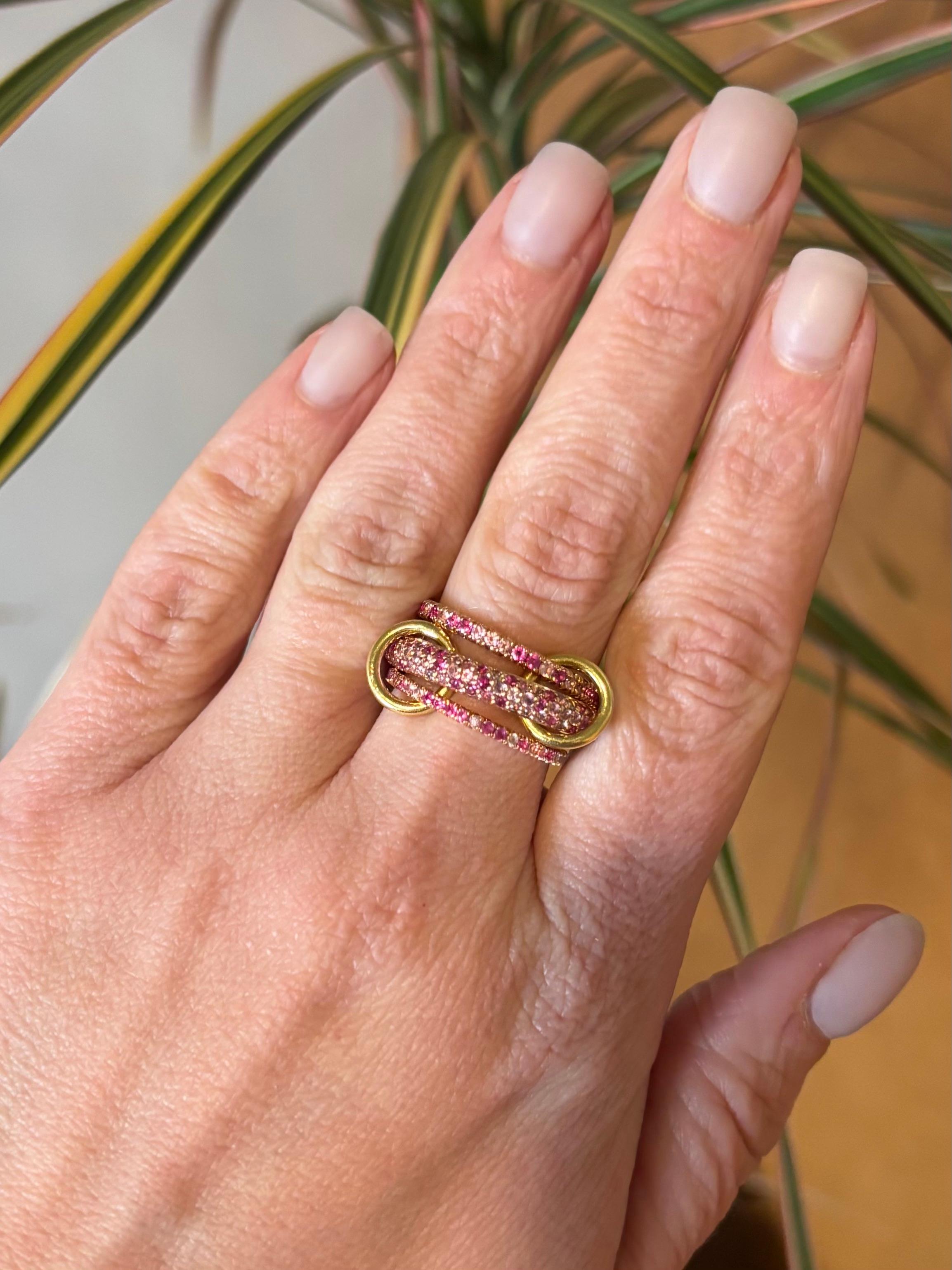 Authentic Spinelli Kilcollin Nova Rose ring made in 18k Rose Gold, with original box. The ring can be worn stacked, or across multiple fingers. 

Gemstone: Pink & Purple Sapphires
Gemstone Cut: Round Brilliant
Gemstone Carat Weight: Approximately