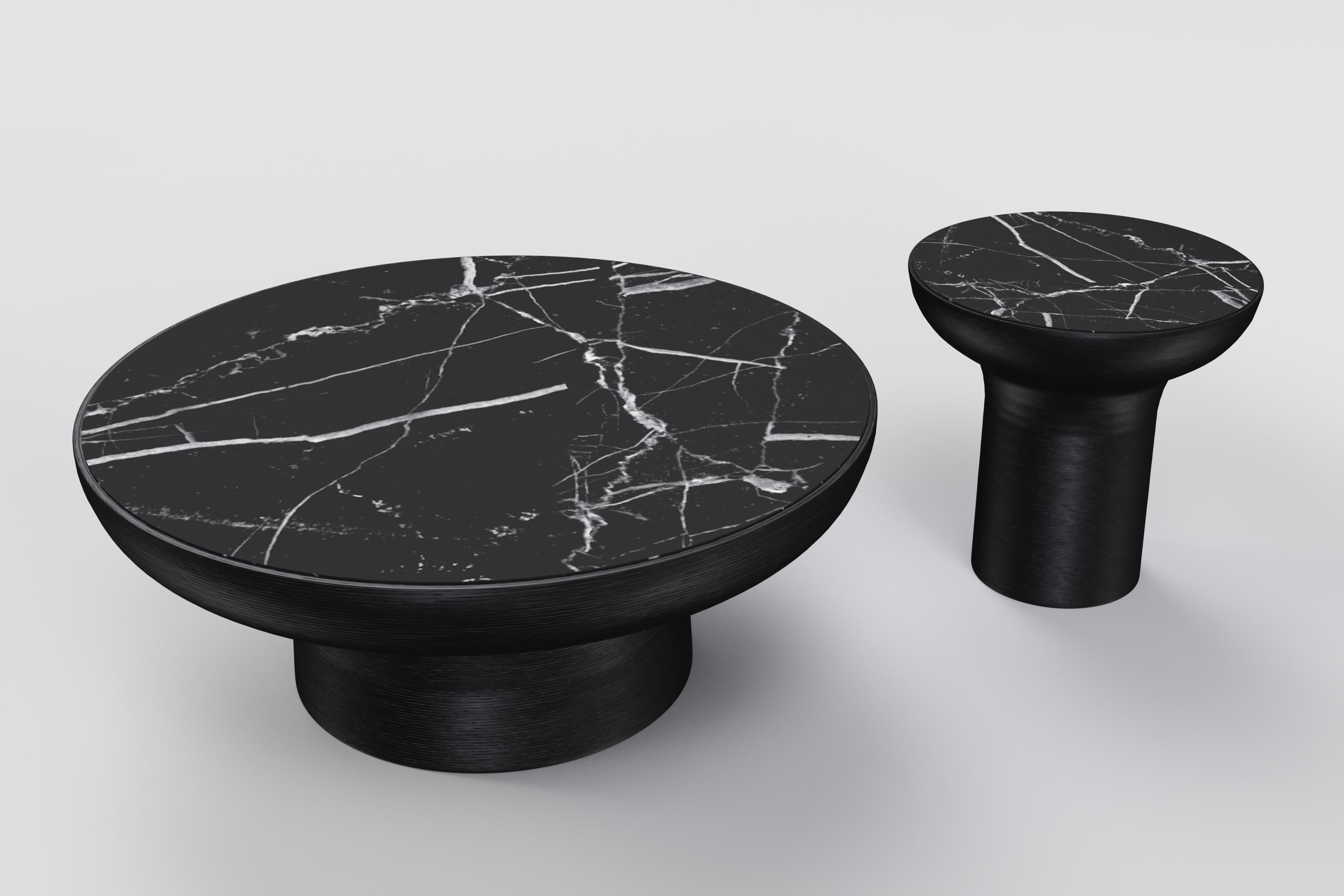 The design is inspired by the traditional art of forming clay on a spin wheel. The coffee table features a black marble top and a black base made with textured resin mold to mimic a thrown piece. 
Measures: Low table: diameter 100cm x height